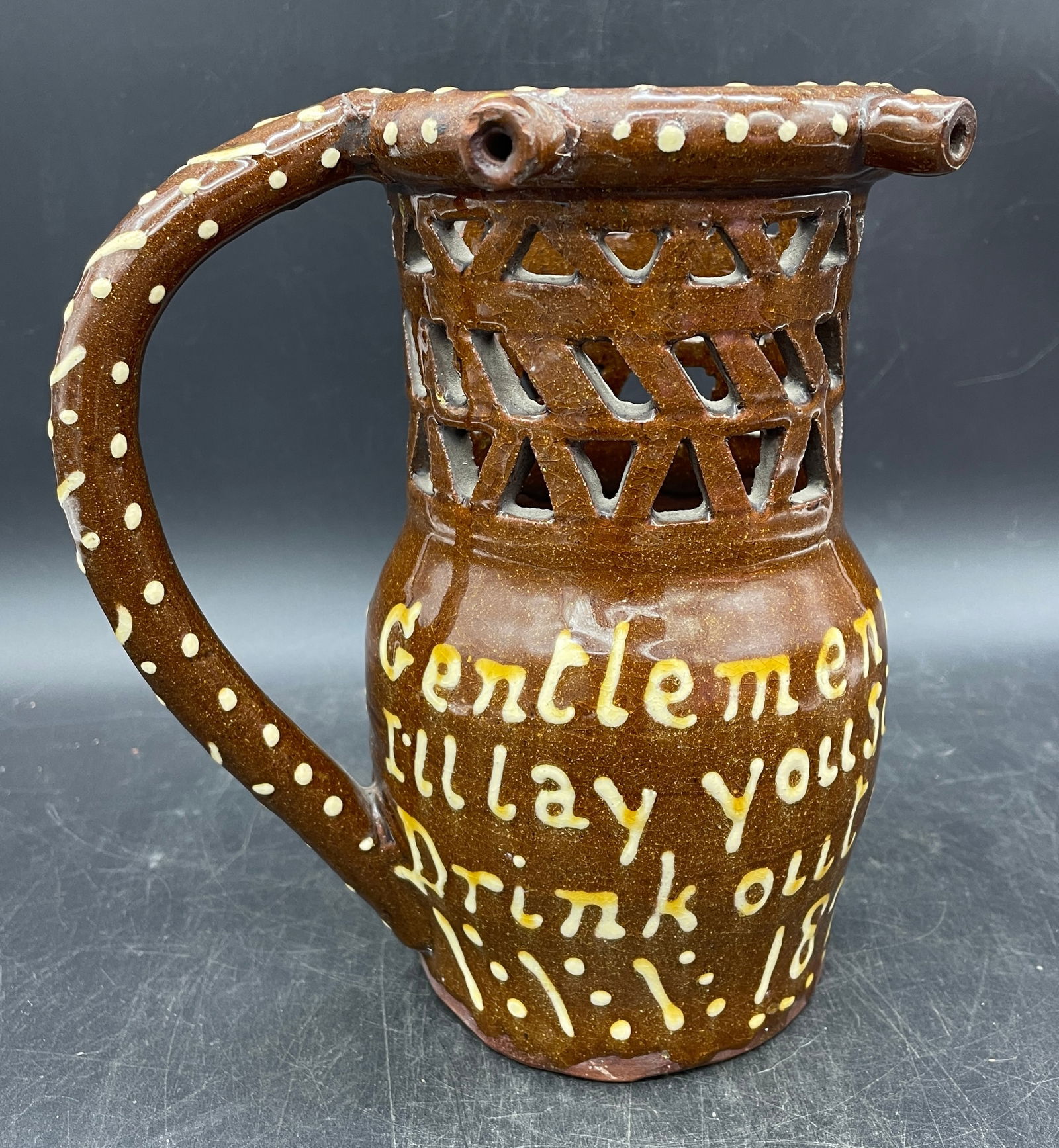 RARE 1874 REDWARE POTTERY YELLOW SLIP DECORATED RETICULATED PUZZLE MUG: Title: RARE 1874 REDWARE POTTERY YELLOW SLIP DECORATED RETICULATED PUZZLE MUG Date/Period: 1874 Dimension: APPROX 7 X 6 X 4.5 Material: REDWARE Additional Information: REDWARE POTTERY YELLOW SLIP DECO