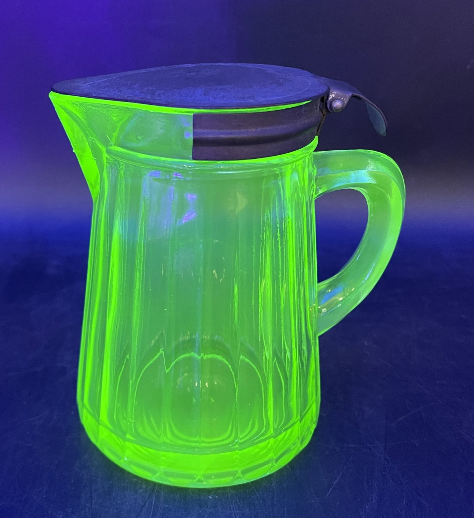 GREEN URANIUM VASELINE KITCHEN RIBBED DEPRESSION SYRUP DISPENSER PITCHER: Title: GREEN URANIUM VASELINE KITCHEN RIBBED DEPRESSION SYRUP DISPENSER PITCHER Date/Period: APPROX 1930'S Dimension: approx 4x.5 x 4 x 3 Material: GLASS Additional Information: GREEN URANIUM VASELINE