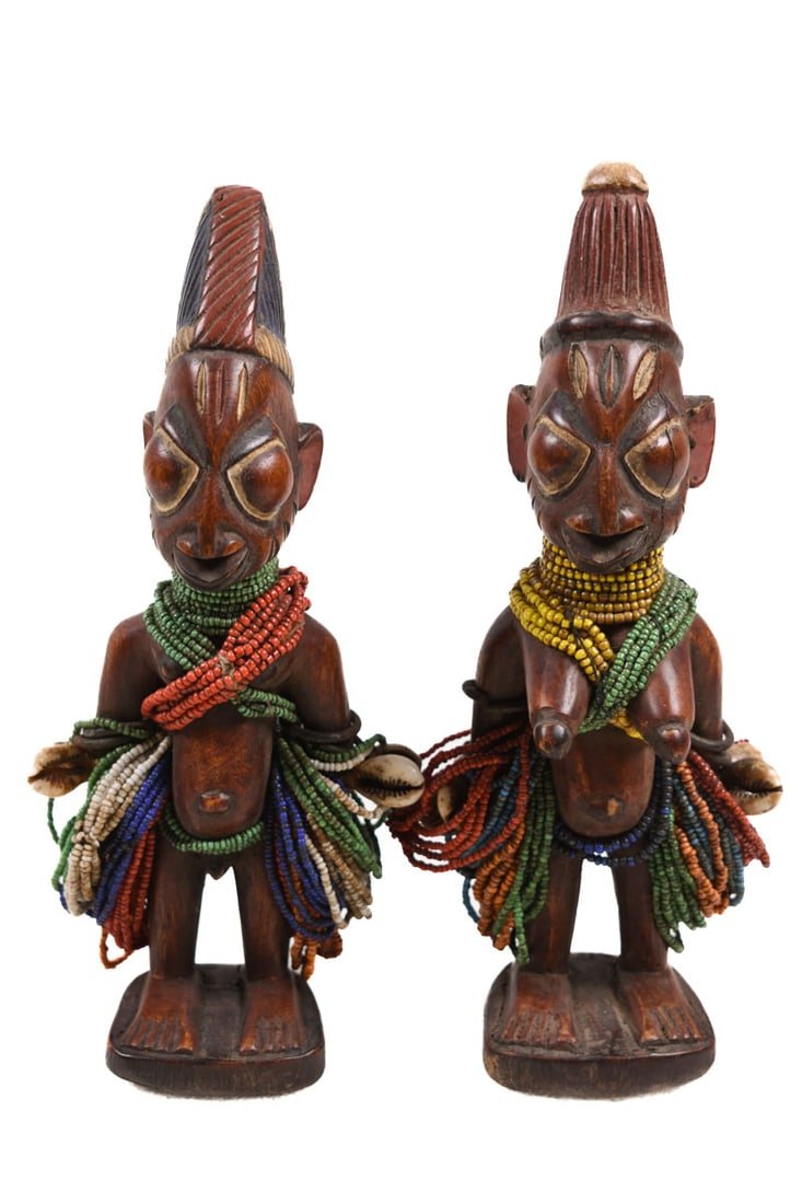 Ibeji Twins - Glass beads, Wood - Yoruba - Nigeria: Appealing Ibeji twins of the YORUBA tribe of Nigeria. One of the most famous Yoruba Ibeji woodcarvings is the figures that represent deceased twins. According to Yoruba faith, they affect the daily li