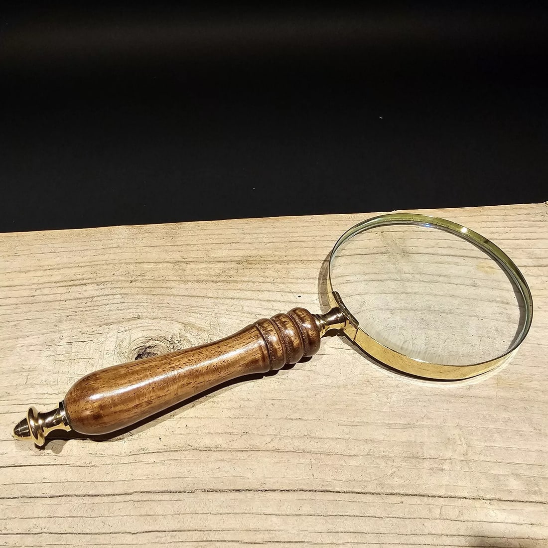 Magnifying Glass w Wood Turned Handle: 4" Wide lens x 9 1/2" Long. Nice reproduction of an antique Magnifying glass, with a turned wood handle. The magnification is not specified unfortunately. Magnifying glasses like this were used in the
