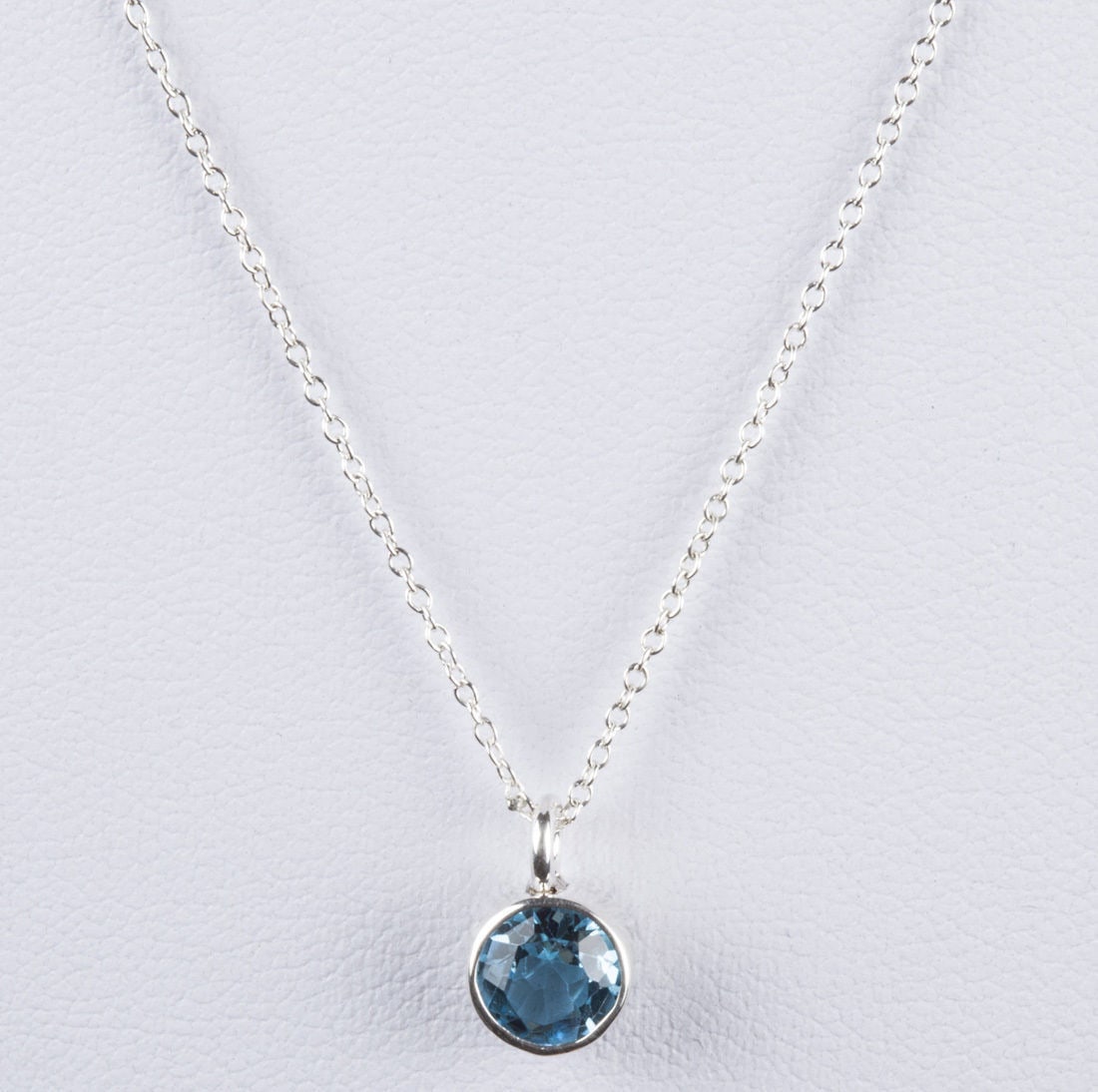 Sterling Silver Faceted Blue Topaz December Astrology Pendant & Necklace: This 12 piece astrology necklace collection is an extension of my 2nd collection called "Plain Jane", a long side the modernist inspired hair combs. This necklace measures 16 1/2" long. Comes with a p