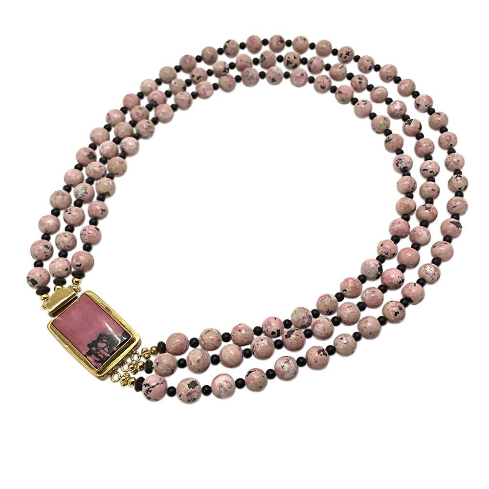 Rhodonite Triple Strand Necklace: This triple strand necklace was created by Nouveau Boutique with 10 mm matt rhodonite beads and smaller jet beads as spacers. It is hi-lighted with a large rectangle (1.5" x 1") polished rhodonite sto