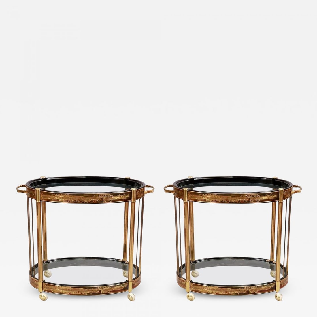 Pair of Mid-Century Modern Mastercraft Bar Cart or Serving Wagons: A pair of Mid-Century Modern master-craft brass acid etched bar-carts or serving wagons. This one of a kind pair of simply stunning bar carts or servers has two oval glass polished edge shelves suppor