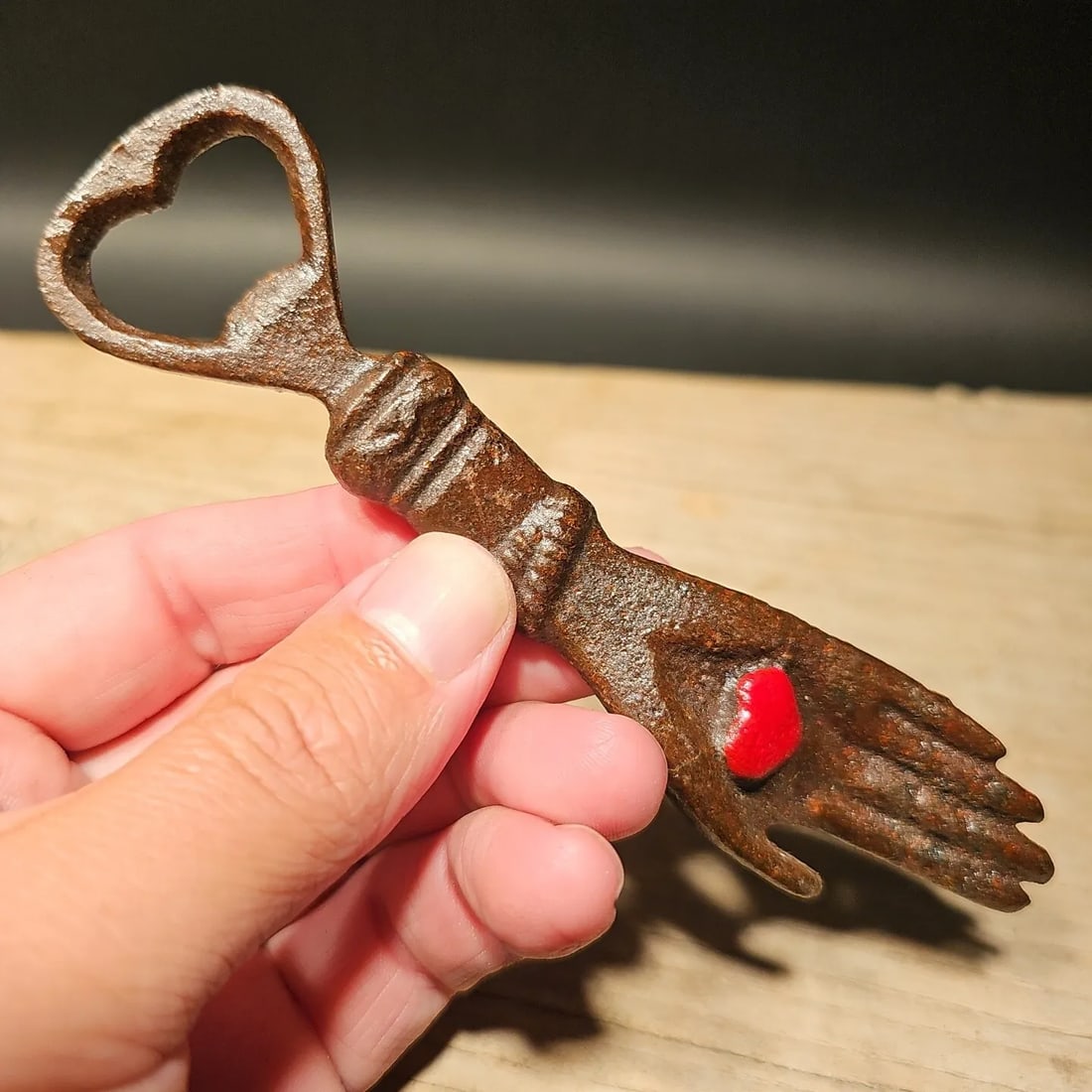 Cast Iron Heart in Hand Odd Fellows Bottle Opener: 5 3/4" long x 1 1/2" Wide A wonderful reproduction cast iron heart in palm bottle opener. Many times the symbol of a heart in an open palm is symbolic of an open welcome or charity. It has also been t