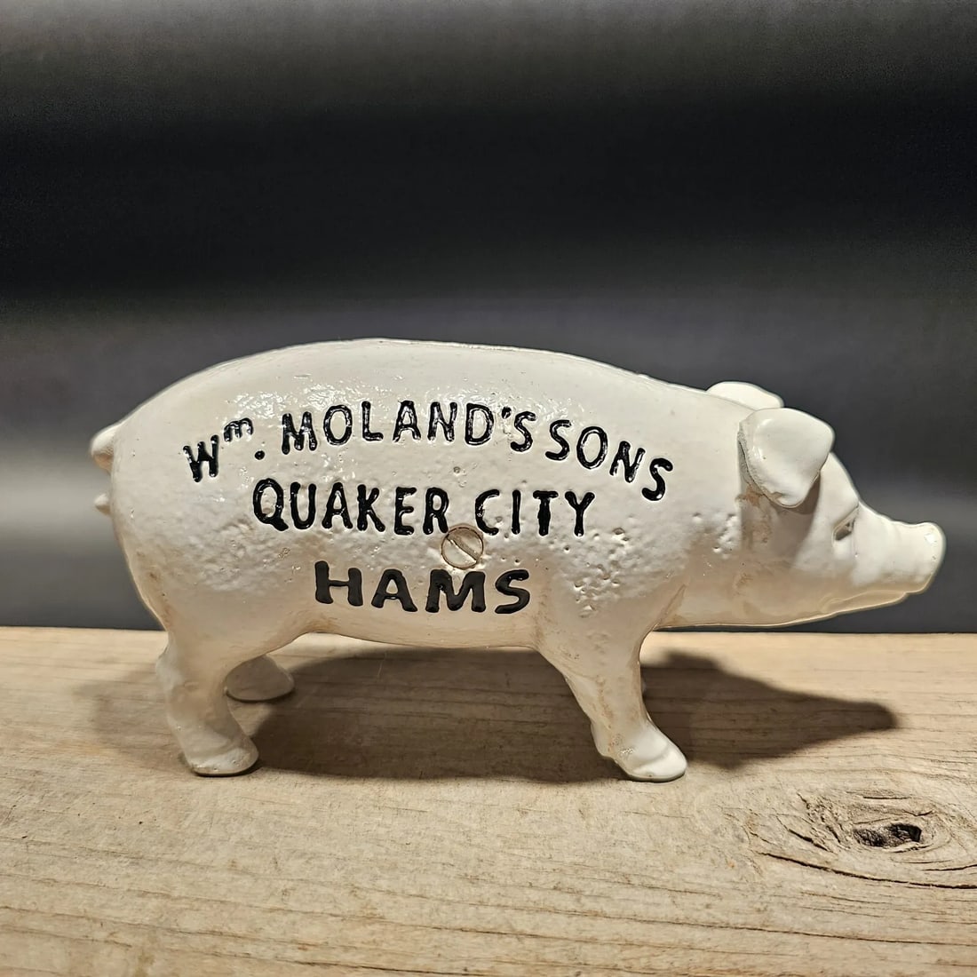 Cast Iron Quaker City Hams Pig Coin Bank: 7 1/2" Long x 2 1/2" Wide Great reproduction folk art cast iron coin bank. This piece was made to look just like an antique, but is actually new. Reserve: $25.00 Shipping: Domestic: Flat-rate of $18.0
