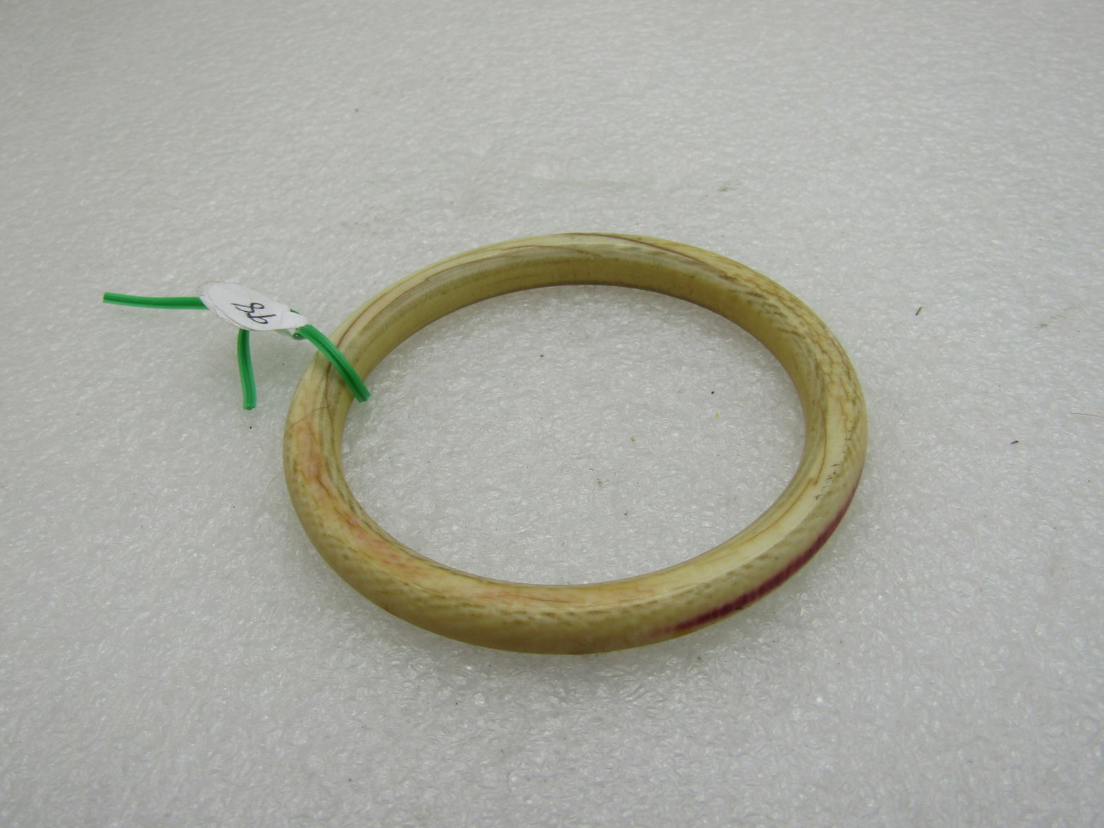 Vintage Carved Bone Bangle Bracelet 7" Inside: Vintage carved bone bangle bracelet, 7" inside measurement and 2.5" opening - for a slender wrist. It is appx. 7.3mm thick. There is a red sort of stripe on one part of the outer edge. Circa Mid-Centu