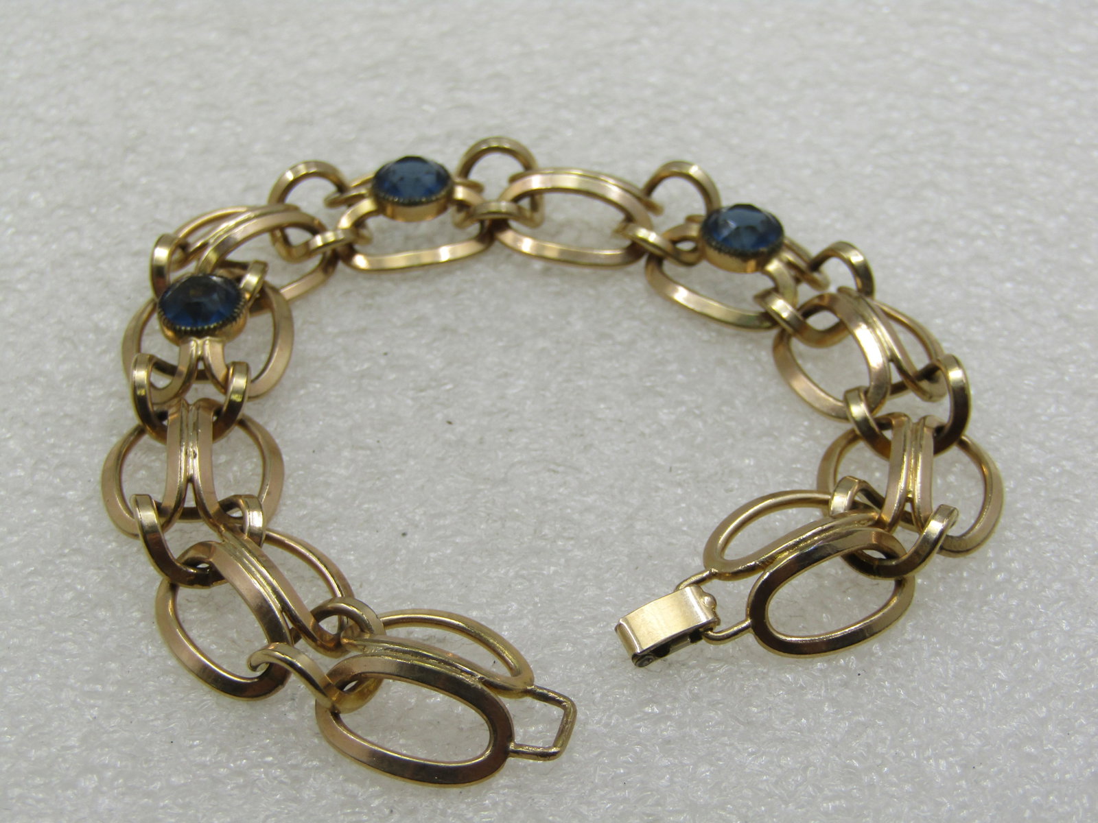 Vintage Simmons GF Blue Stone Bracelet, 7.25", 1930's-1940's: Vintage Simmons GF Blue Stone Bracelet, 7.25", 1930's-1940's. Three ilnks have a 7mm round bezel-set blue sapphired colored glass stone and are center on the bracelet and on each end there are three d