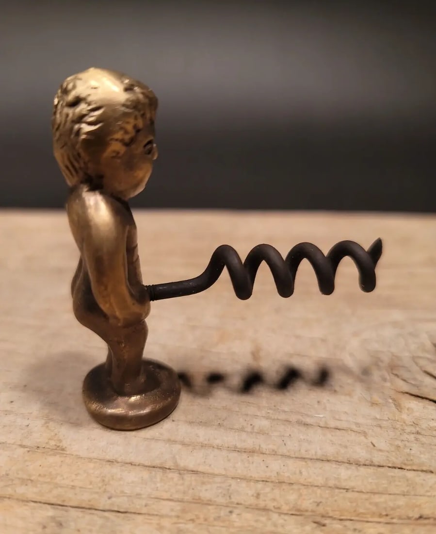 Boy Brass & Iron Corkscrew: 2 1/2" Tall x 2 1/4" Wide Nice quality reproduction corkscrew. Made to look just like an original antique but is new. Wonderful tool marks patina and signs of being handmade. Great for use or display!
