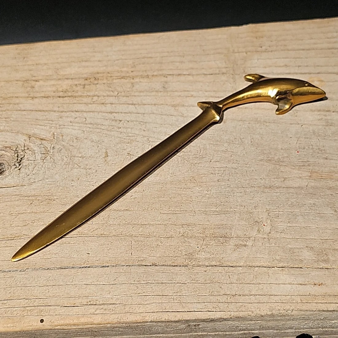Brass Dolphin letter opener Desk Collectible: 7 1/4" long Introducing the Reproduction Antique Brass Letter Opener with Dolphin Detail: This exquisite reproduction antique letter opener is a true embodiment of timeless elegance and sophistication