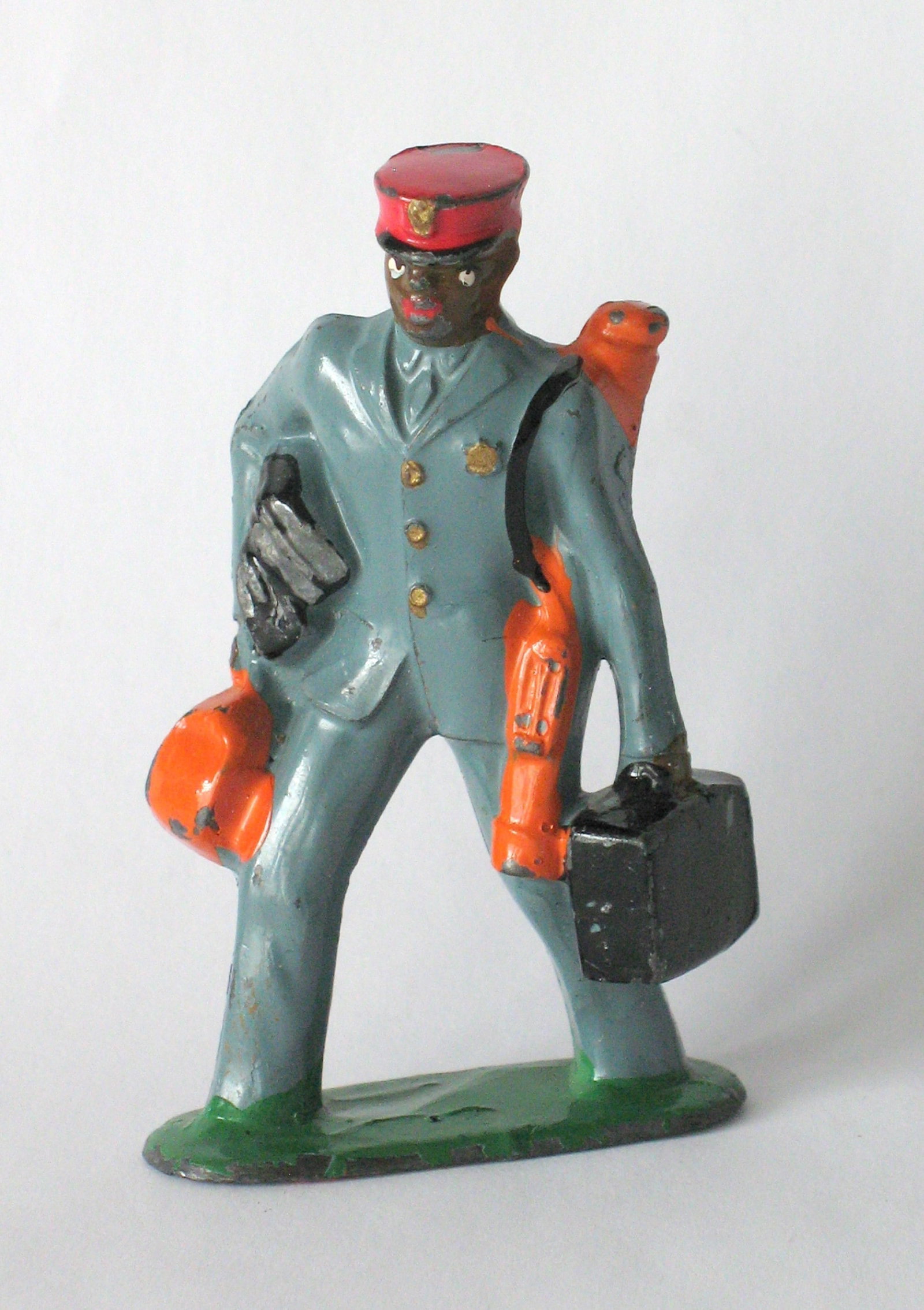 Vintage cast metal train porter figure: Title: Vintage cast metal train porter figure Date/Period: 1940's Dimension: 3 1/4” high Additional Information: Nice vintage cast metal train porter in great all original paint, patina & condit