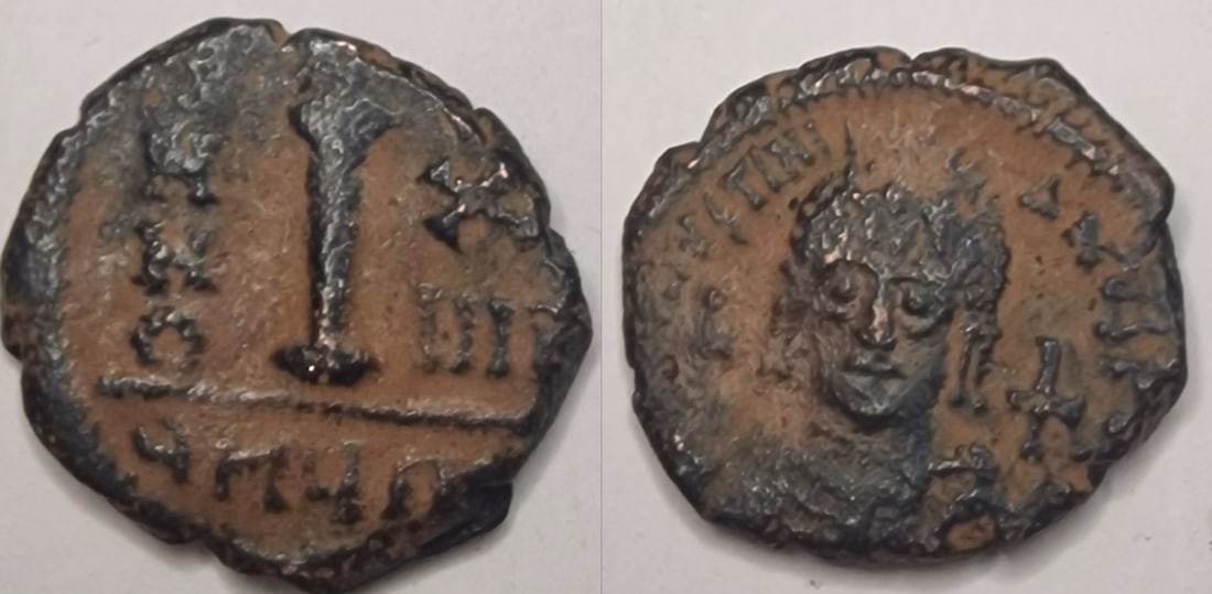 The Byzantine Empire: Title: The Byzantine Empire Description: Helmeted and cuirassed bust facing, holding globus cruciger and shield, cross to right. Date/Period: 527-565 Materials: bronz coin Dimensions: 19.6 mm Reserve: