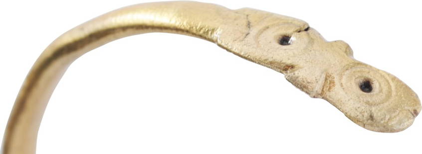 VIKING SERPENT BRACELET, 8TH-10TH CENTURY AD.: Gilt bronze, C form with an abstracted snake or sea serpent head and tapered tail. About 2 3/4” (2.77”) inner dimension for an average arm. Surface texture from burial. Professionally