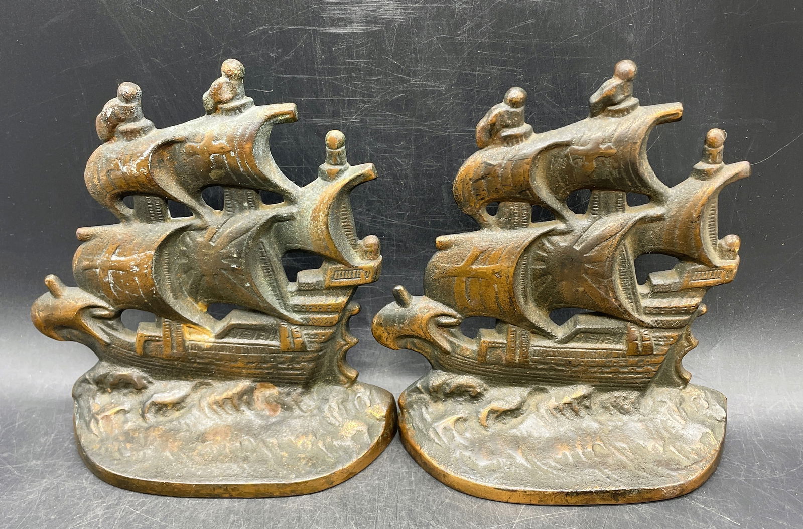 ANTIQUE SPANISH GALLEON COPR 1928 CAST IRON BOOKENDS: Title: ANTIQUE SPANISH GALLEON COPR 1928 CAST IRON BOOKENDS Date/Period: 1928 Dimension: approx 5 x 2 x 6 Material: cast iron Additional Information: ANTIQUE SPANISH GALLEON COPR 1928 CAST IRON BOOKEN