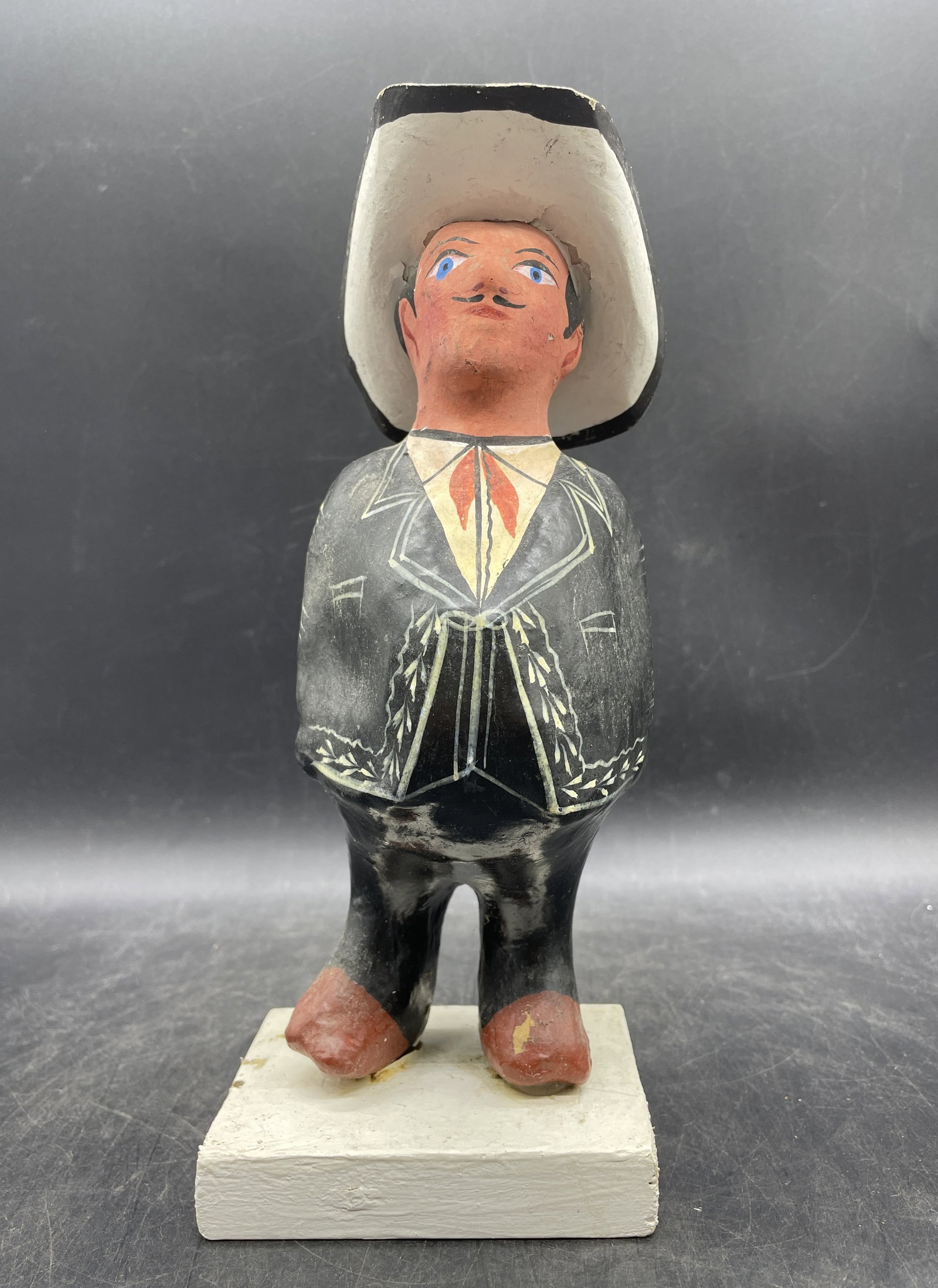 Folk Art Cowboy: Title: Folk Art Cowboy Date/Period: unknown Dimension: Approx. 9.5 x 4 x 3 Material: paper mache Additional Information: Folk Art Cowboy Paper Mache Primitive Shipping: Domestic: Flat-rate of $10.00 t