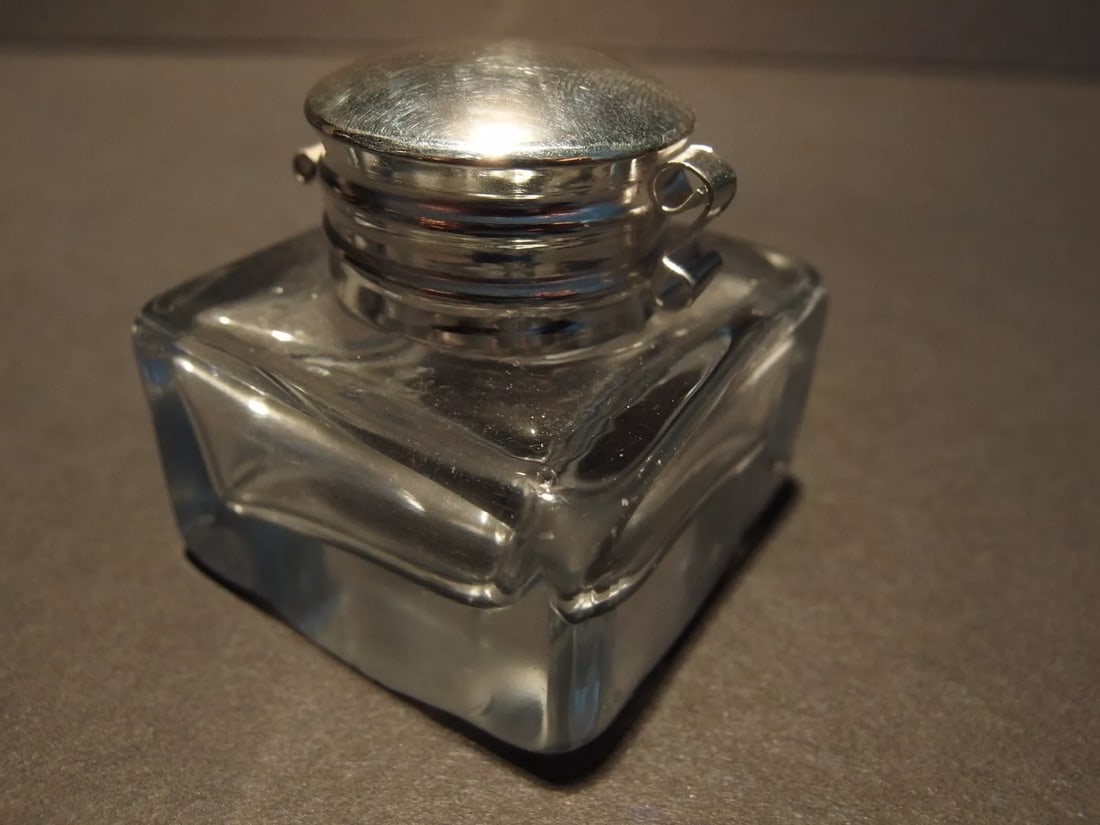 Clear Square Thick Glass Inkwell Ink pot Bottle: Charming 1 3/4" High x 1 3/4" wide Reproduction antique clear glass inkwell. Very heavy thick clear glass each with charming subtle signs of being hand made. The hinged shiny lid is nickel plated bras
