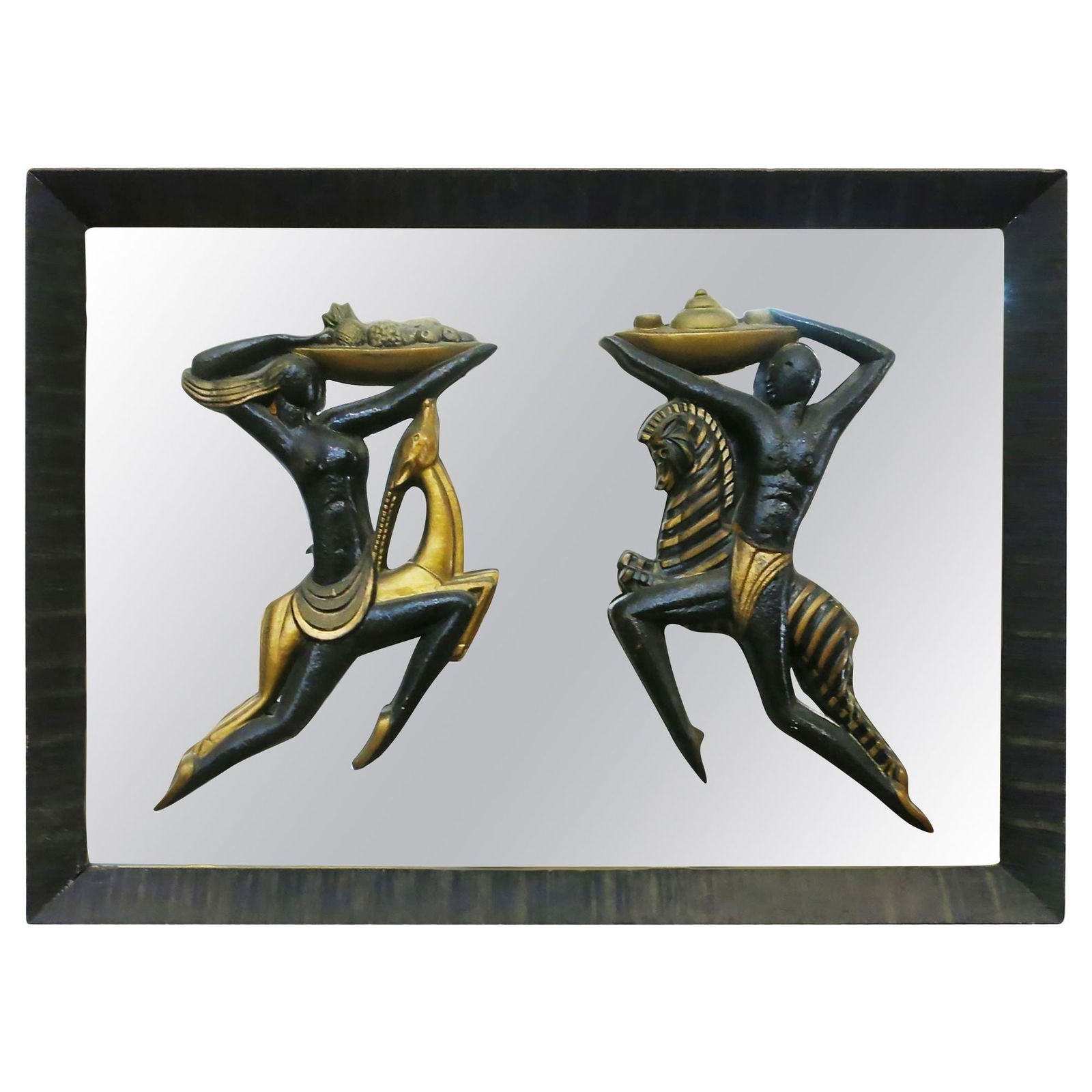 Very Large Midcentury Wall Mirror with Carved Tribal Sculptures in the Center: About the Item Original Mid-century wall mirror with carved tribal male and female sculptures in the center surrounded by a combed wood mirror. Each statue has been hand painted in gold and black lacq