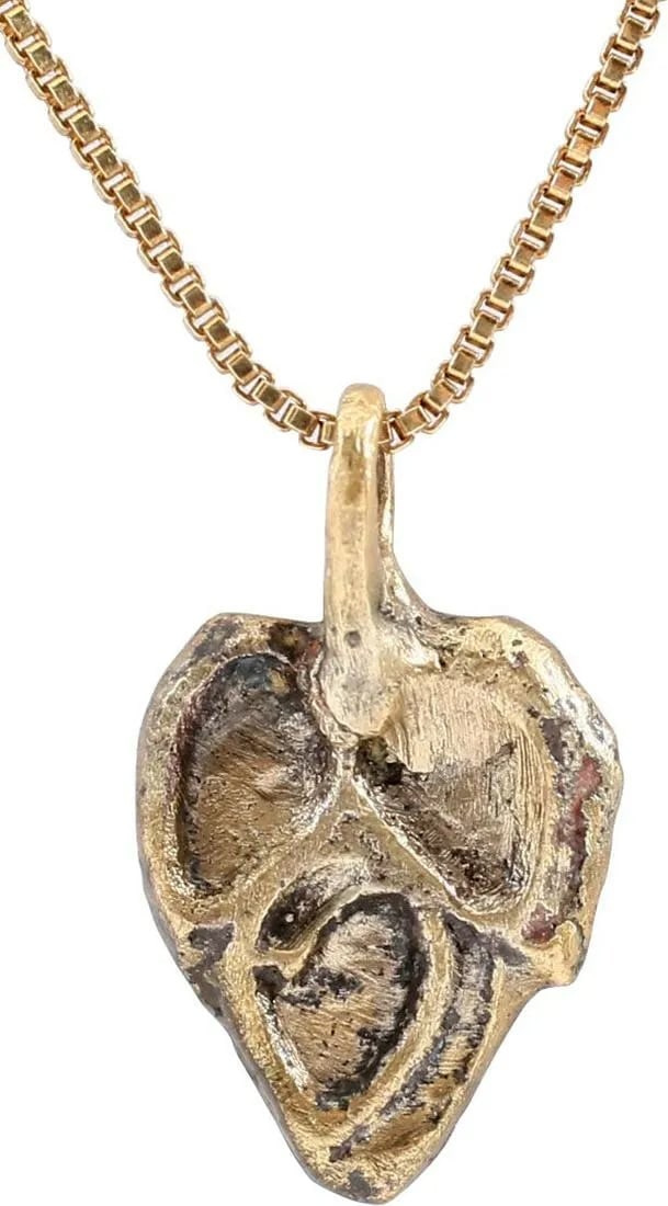 RARE VIKING HEART PENDANT C.900-1000 AD: Slightly under 3/4" height including the suspension loop. Cusped tope and heart form, made of a trefoil (three leaves). The trefoil was a very popular Viking motif, incorporated in half or more of Vik
