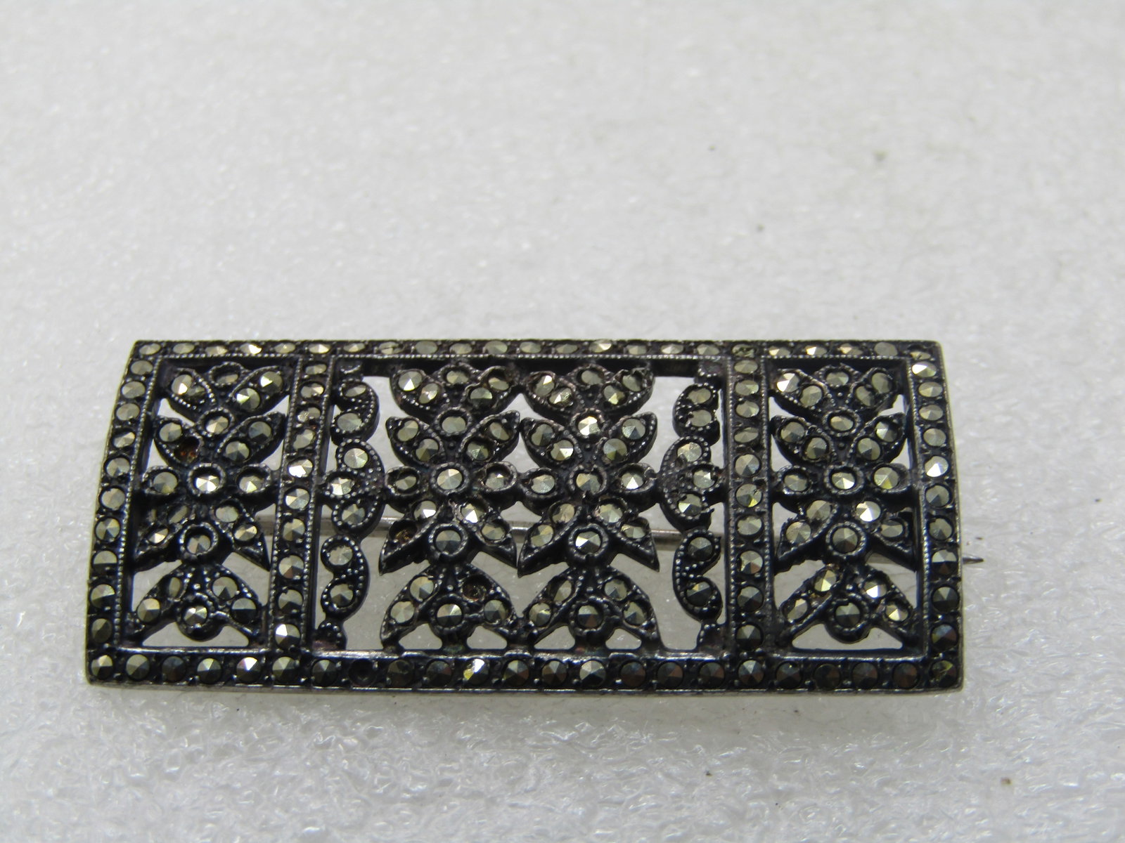 Vintage Sterling Marcasite Floral Brooch, Rectangular, 1-5/8" by 7/8": Vintage Sterling Marcasite Floral Brooch, Rectangular, 1-5/8" by 7/8", appx. 8.15 grams. Marked sterling and tested. 1930's - pin tip extends beyond the frame of the brooch, locking clasp. Open areas 
