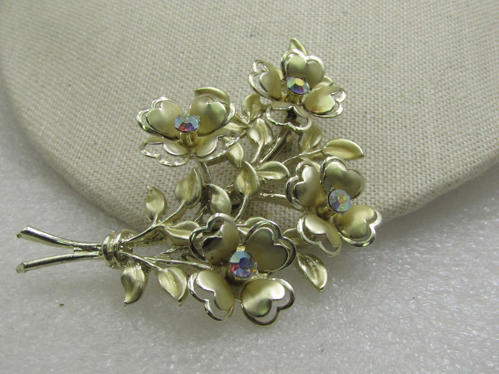 Vintage Coro Floral Bouquet Brooch, AB Rhinestones, Mid-Century: Vintage Coro Floral Bouquet Brooch, AB Rhinestones, Mid-Century. Gold tone with smooth and satin finish and a center aurora borealis rhinestone in each blossom that is appx. 4mm wide. Lots of small sa