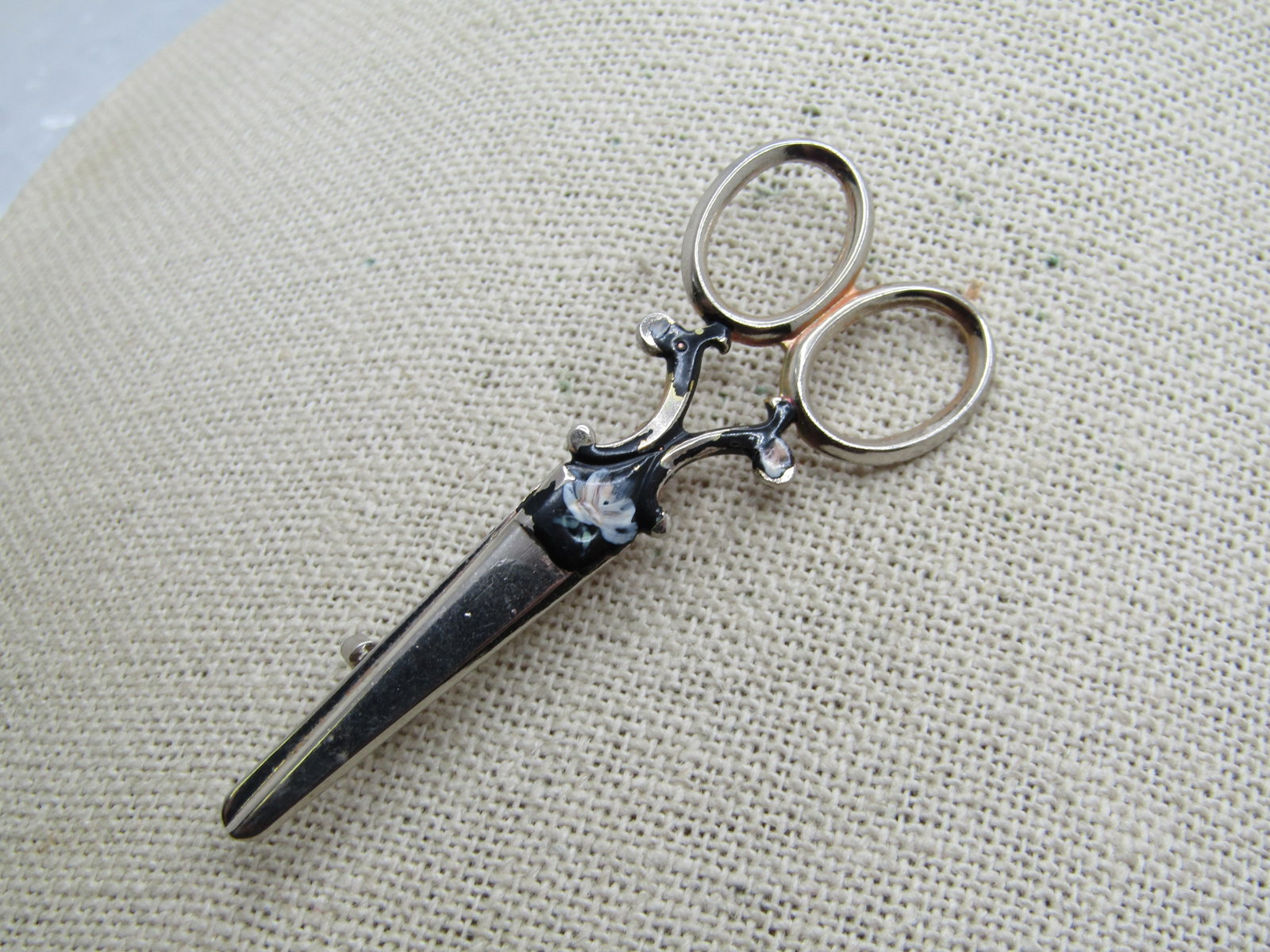 Vintage Enameled Scissors Brooch, With Flower, 2.5", Silver Tone: Vintage Enameled Scissors Brooch, With Flower, 2.5" tall and 1" wide. Silver Tone. Black enameling with a floral accent at the back of the blades and on the curved below the handles - with some wear, 