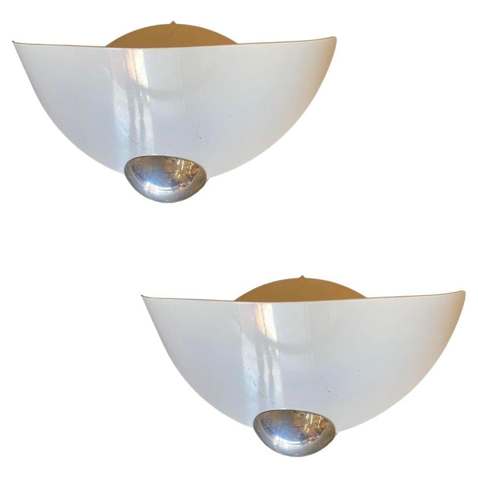Arteluce "Aura" Memphis Wall Sconce by Perry King & Santiago Miranda: About the Item A pair of Aura wall lights made by the famous designers Perry King & Santiago Miranda and produced by Arteluce. Each wall sconce is made of white enameled panels forming a Memphis strea