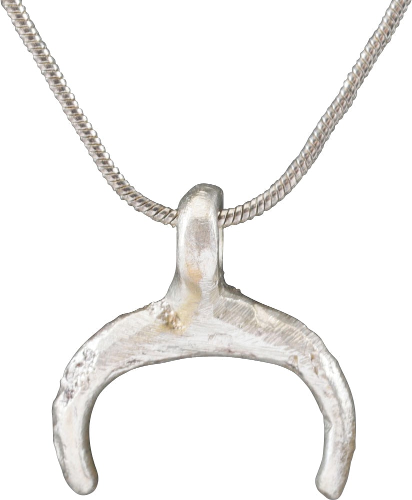 VIKING LUNAR PENDANT NECKLACE, C.950-1050 AD: Small example, just over 3/4” total height. As expert navigators, the constellations signified mystery and power to Vikings. The Moon was personified as Mani, brother to Sol the Sun, and is abun