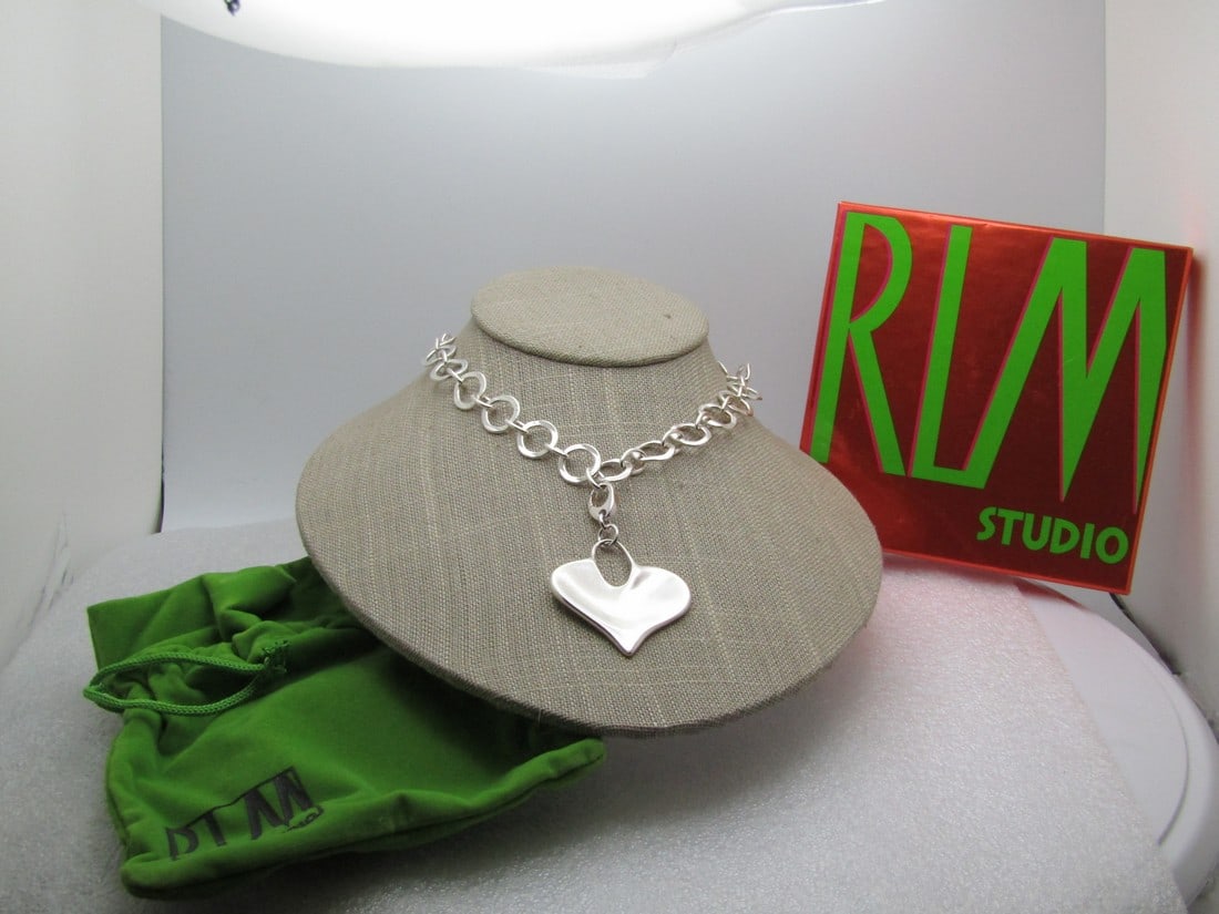 Robert Lee Morris Sterling Heart Necklace, Toggle Clasp, 18" Original Box and Pouch: Robert Lee Morris Sterling Heart Necklace, Toggle Clasp, 18" Original Box and Pouch. 1.75" tall smooth and wavy heart pendant that is 1.5" wide. It is signed RLM Studio Thailand and marked .925. The c