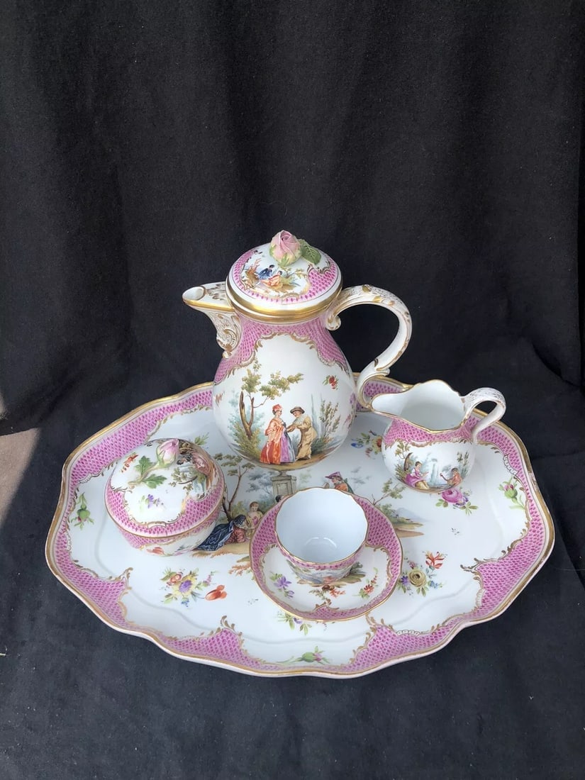 5pc Meissen Watteau Tea Set: The tray measures 14 3/8” x 11 1/8” and is marked. It has a small repair on the rim. The teapot is 8 1/4” high and is marked. The finial flower has chipping, the underside of the lid