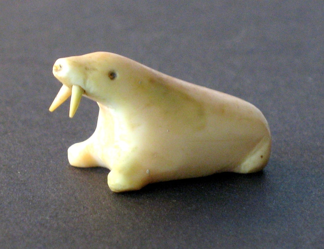 Antique Northwest Coast bone walrus paper weight.: Title: Antique Northwest Coast bone walrus paper weight.Date/Period: 1930'sDimension: 1 1/4” longAdditional Information: Very nice vintage Northwest Coast walrus paper weight hand made from whal