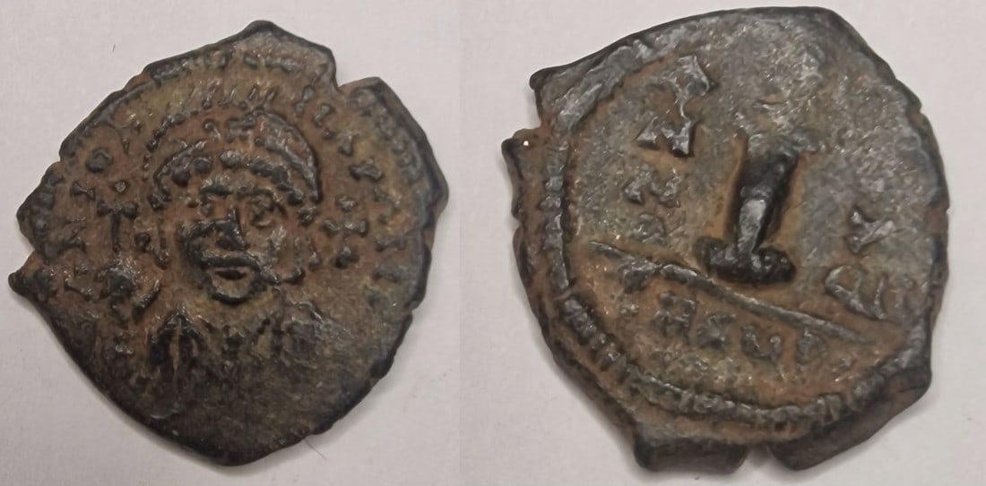 The Byzantine Empire: Title: The Byzantine Empire Description: Maurice Tiberius (582-602). AE Decanummium. Theupolis (Antioch) mint. RY 17 (598/9 AD). Date/Period: 582-602 Materials: bronz coin Dimensions: 19.8 mm Reserve:
