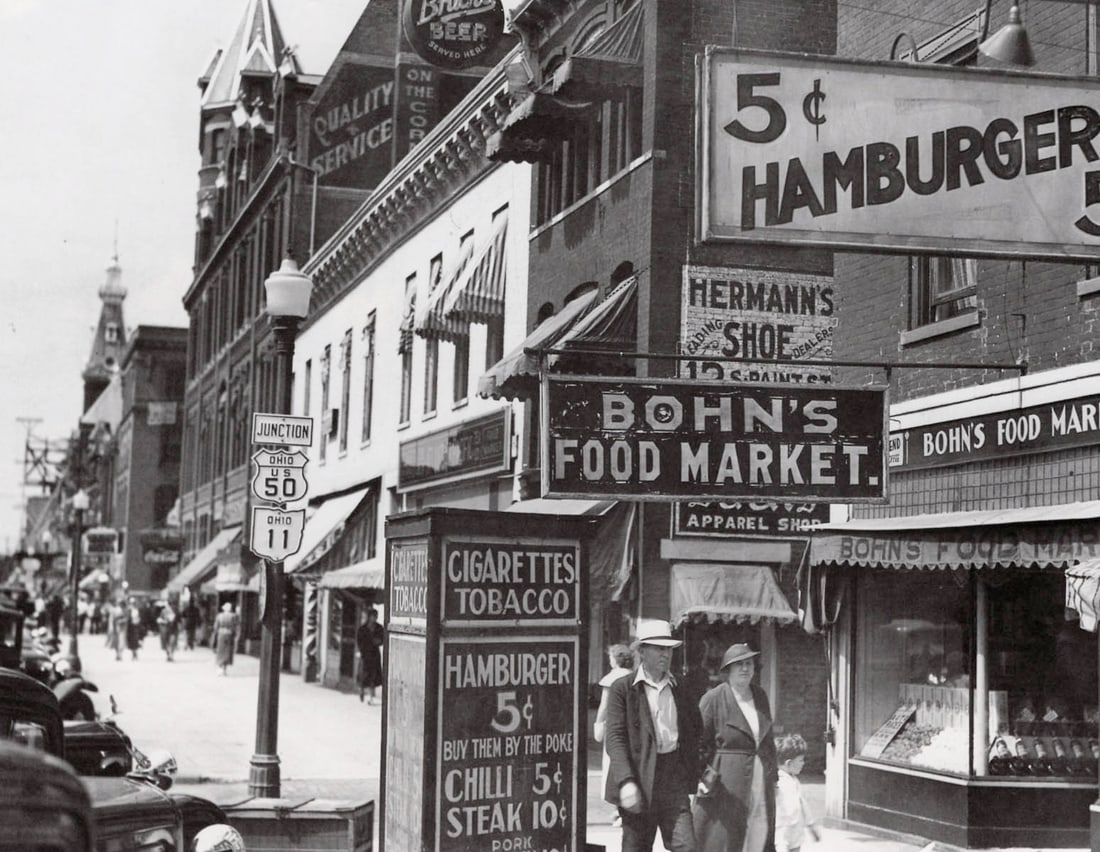 BERENICE ABBOTT - Main Street, Chillicothe, Ohio: Artist: BERENICE ABBOTT Print Title: Main Street, Chillicothe, Ohio Printing Date: 1980s Medium: Duotone Photolithograph Printed in: Japan Image Size approx: 6 x 7.5” Berenice Abbott (1898 ̵