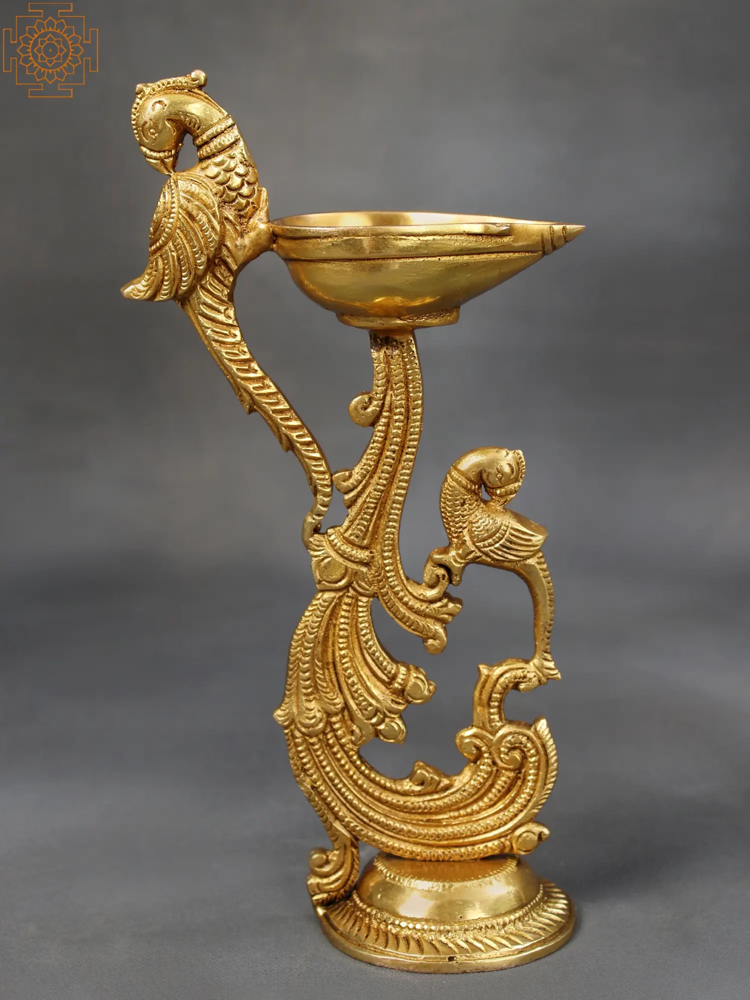 Ritual Diya Stand With Double Parrot | Brass Stand: Title: Ritual Diya Stand With Double Parrot | Brass Stand Description: Brass Height: 8.6 inch Width: 4.9 inch Depth: 2.5 inch Weight: 600 gm Additional Information: This basic yet attractive Pooja sta