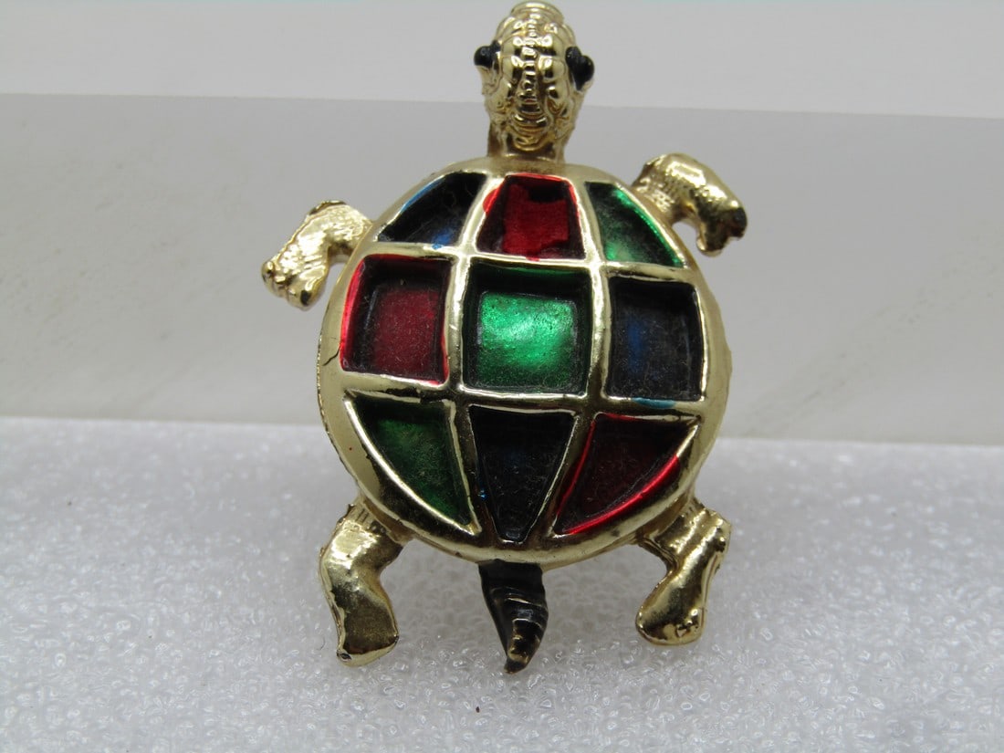 Vintage Red and Green Enameled Turtle Brooch, 1960's: Vintage Red and Green Enameled Turtle Brooch, 1960's. Recessed sections to the shell where it is enameled in blue, red and green. The turtle has black beaded eyes. The enameling is on the frame of the