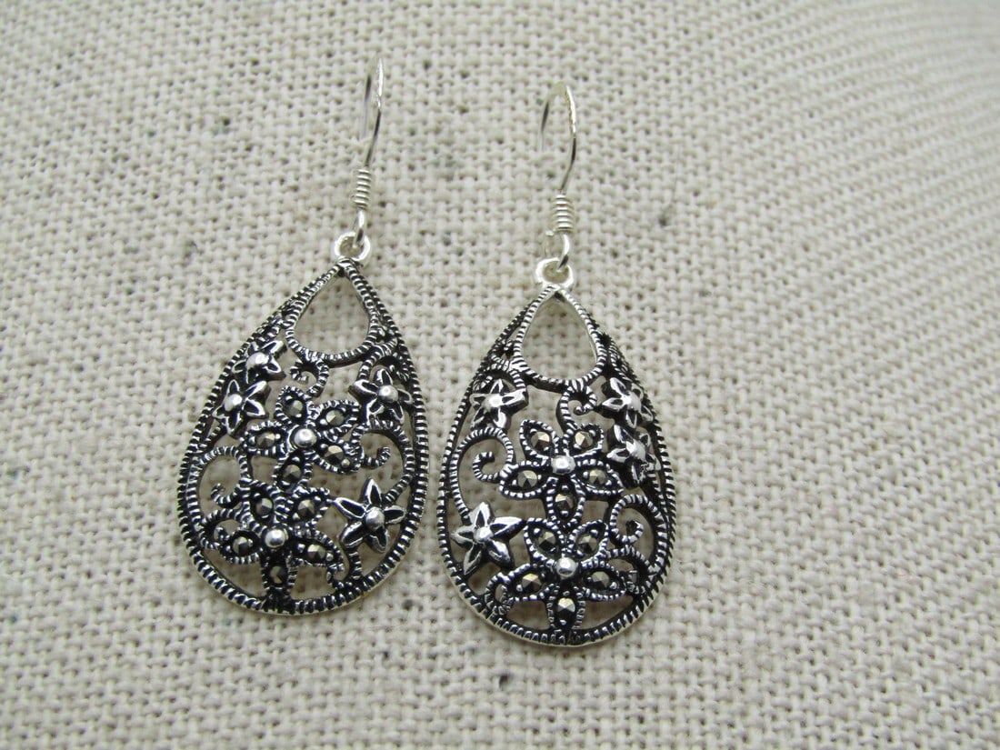 Vintage Sterling Marcasite Floral Earrings, Pierced, Drop, 1980's-1990's, Signed: Vintage Sterling Marcasite Floral Earrings, Pierced, Drop, 1980's-1990's, Signed Marsala. They are teardrop shaped drops with floral blossoms - some with marcasite accents. Domed open-work scrolling t
