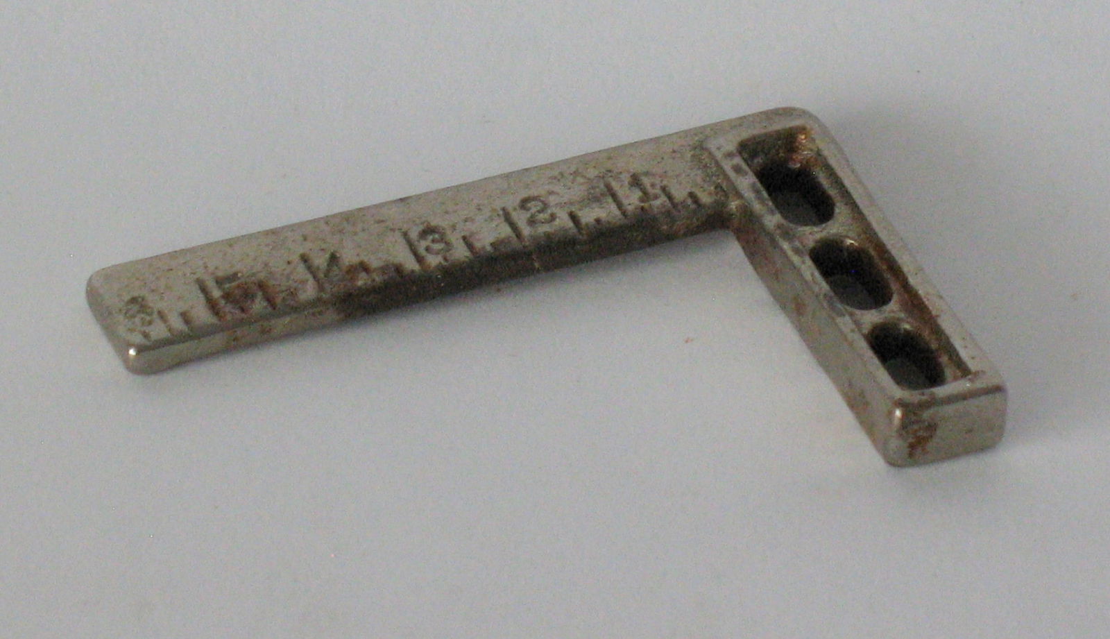 Antique cast iron carpenter's square paper weight.: Title: Antique cast iron carpenter's square paper weight. Date/Period: 1930's Dimension: 2” long Additional Information: Antique cast iron carpenter's framing square paper weight in great origin