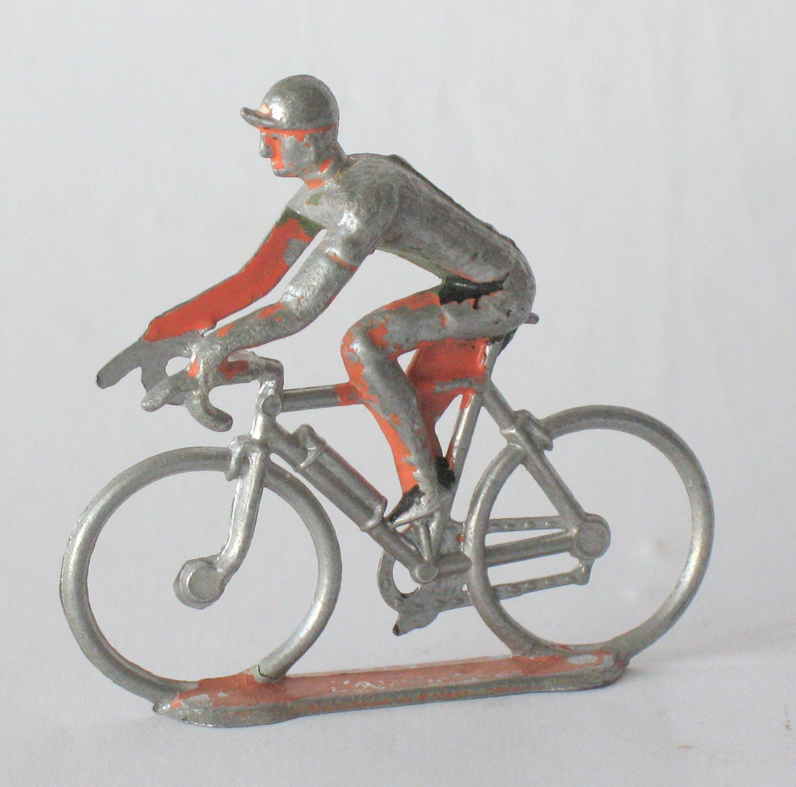 Vintage cast metal bicycle & rider paper weight.: Title: Vintage cast metal bicycle & rider paper weight. Date/Period: 1950's Dimension: 2 1/4” long Additional Information: Nice vintage cast metal bicycle & rider paper weight in old paint, pati