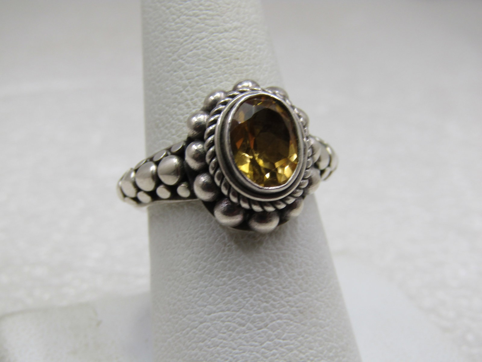 Sterling Citrine Bali Style Ring, Sz. 8, Signed BA (Suarti) Indonesia: Sterling Citrine Bali Style Ring, Sz. 8, Signed BA (Suarti) Indonesia. The ring has a bezel-set 9mm by 7mm yellow citrine with rope accent around that and appx 3mm round beaded halo at the base. The t