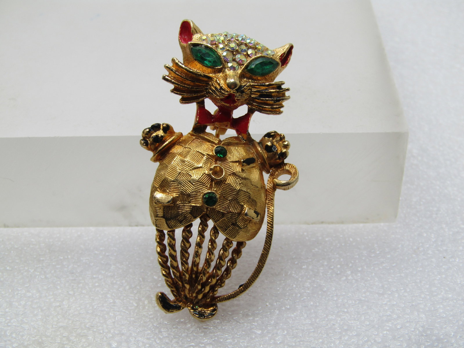 Vintage Sophisticated Cat Brooch, Enameled & Rhinestones, 1960's: Vintage Sophisticated Cat Brooch, Enameled & Rhinestones, 1960's. Gold tone cat wearing a vest with red enameled bowtie and inside ear area with enameled black accents on the best, paws and at whisker