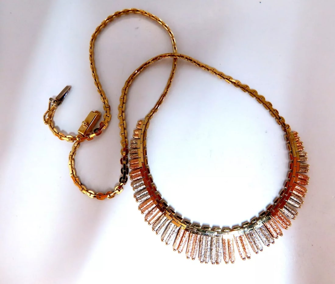 Inspiring Instrumental Portative Organ Graduating Tubular Linked Necklace 14kt: Graduating Musical Instrumental Portative Organ Necklace Necklace: 17 Inches (wearable length) Each Section Caliber 3mm Wide Center Tubes: 5-12mm 14kt. yellow gold 17.6 Grams. Comfortable Slip Clasp L