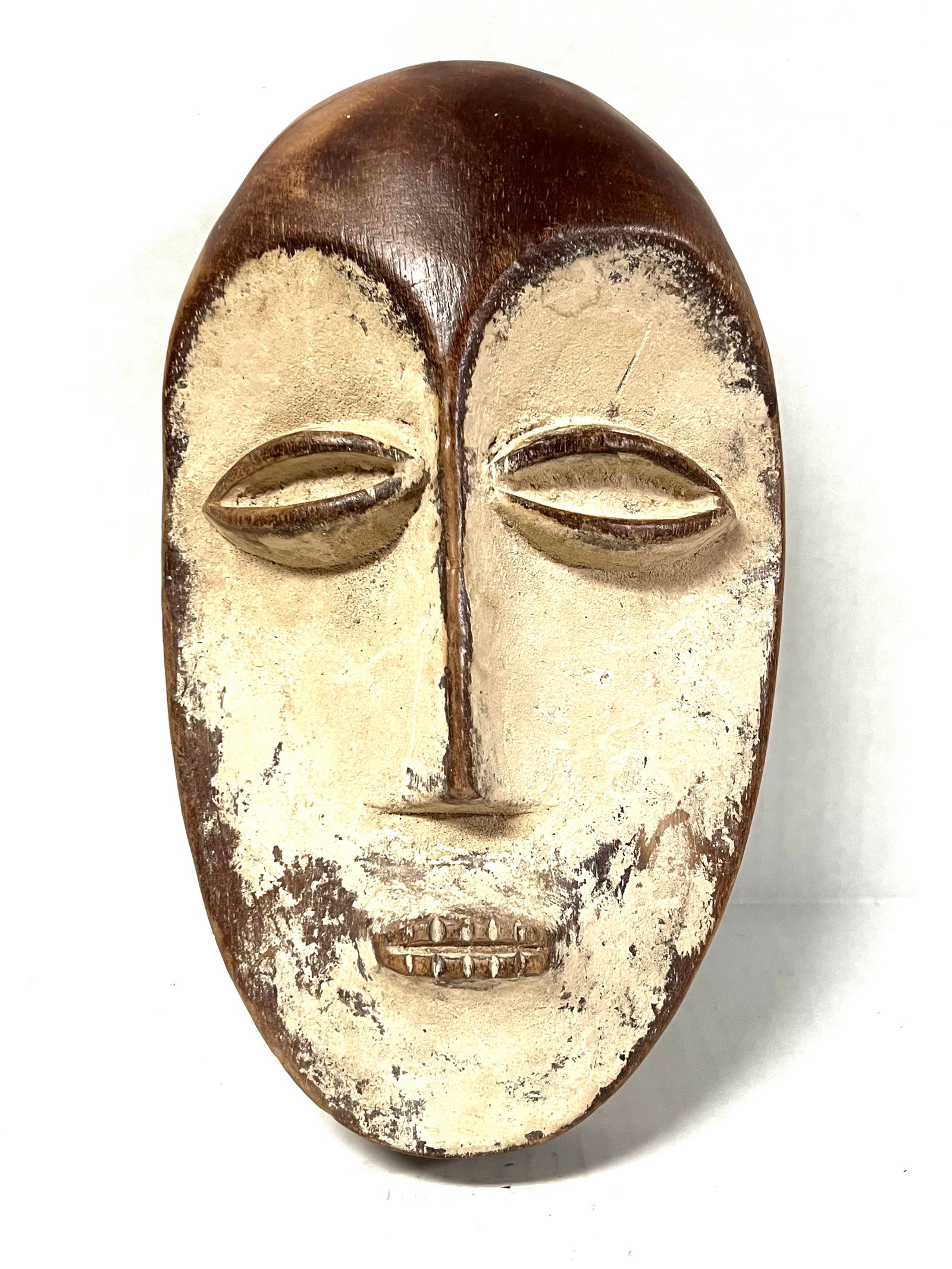 Lega Mask: Title: Lega Mask Date/Period: Late 20th Century Dimension: 10.5" h x 6" w Material: Wood Additional Information: African Tribal Art Lega Mask Reserve: $60.00 Shipping: Domestic: Flat-rate of $30.00 to