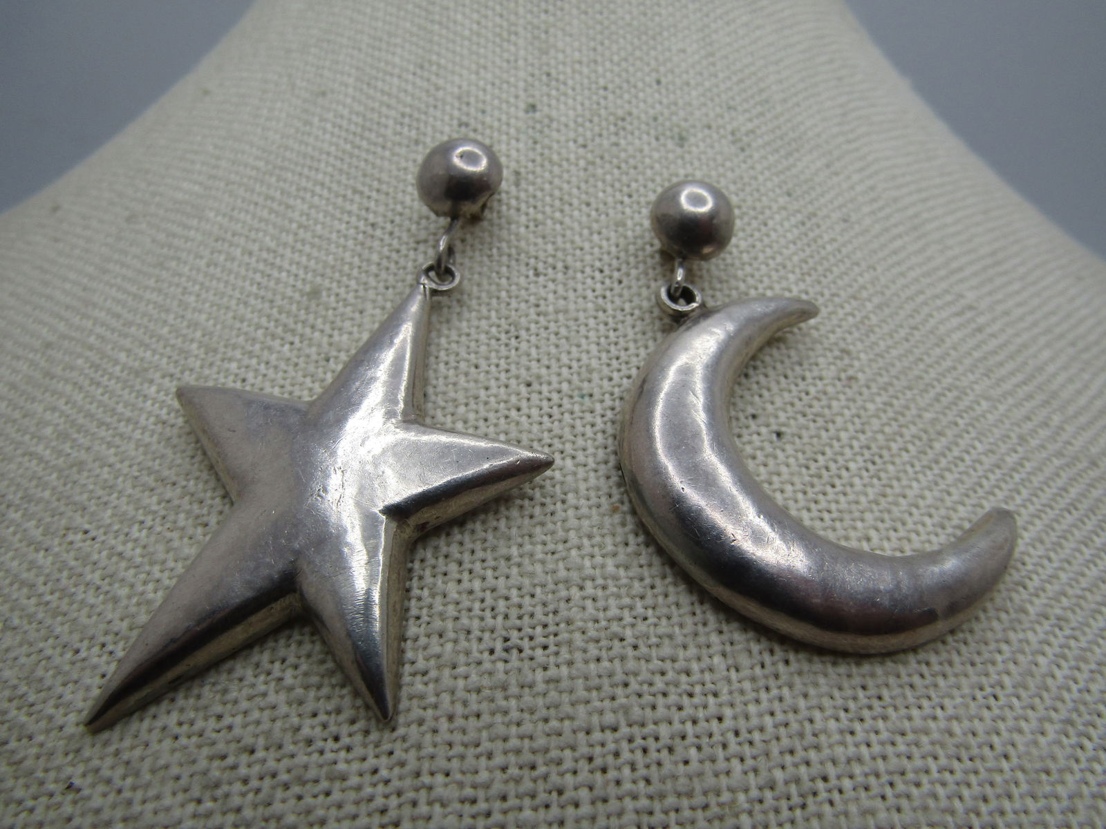 Vintage Sterling Celestial Earrings, Star & Crescent Moon, 1980's-1990's: Vintage Sterling Celestial Earrings, Star & Crescent Moon, 1980's-1990's. Round nearly 8mm stud with one earring having a dangle crescent moon and the other a start. They are marked .925 on the back o