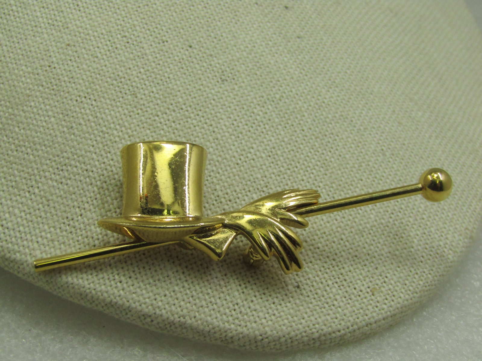 Vintage Monet Top Hat, Gloves, Cane Brooch, 1980's: Vintage Monet Top Hat, Gloves, Cane Brooch, 1980's, 3" long and 1.25" tall - all gold tone and smooth and shiny finish. Signed Monet, age estimated at 1980's. Very good condition. (W 4922.6 SS7084 J L