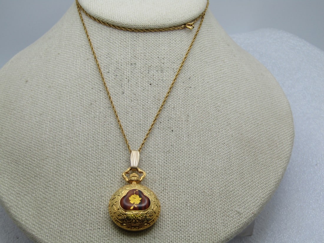Vintage Rose Locket Watch Necklace, Quartz, Signed Arnex, 1960's-1970's: Vintage Rose Locket Watch Necklace, Quartz, Signed Arnex, 1960's-1970's, 24" chain that is appx. 1.2mm wide with spring clasp. It has a decorative case with a rose sitting over a woodgrain background 