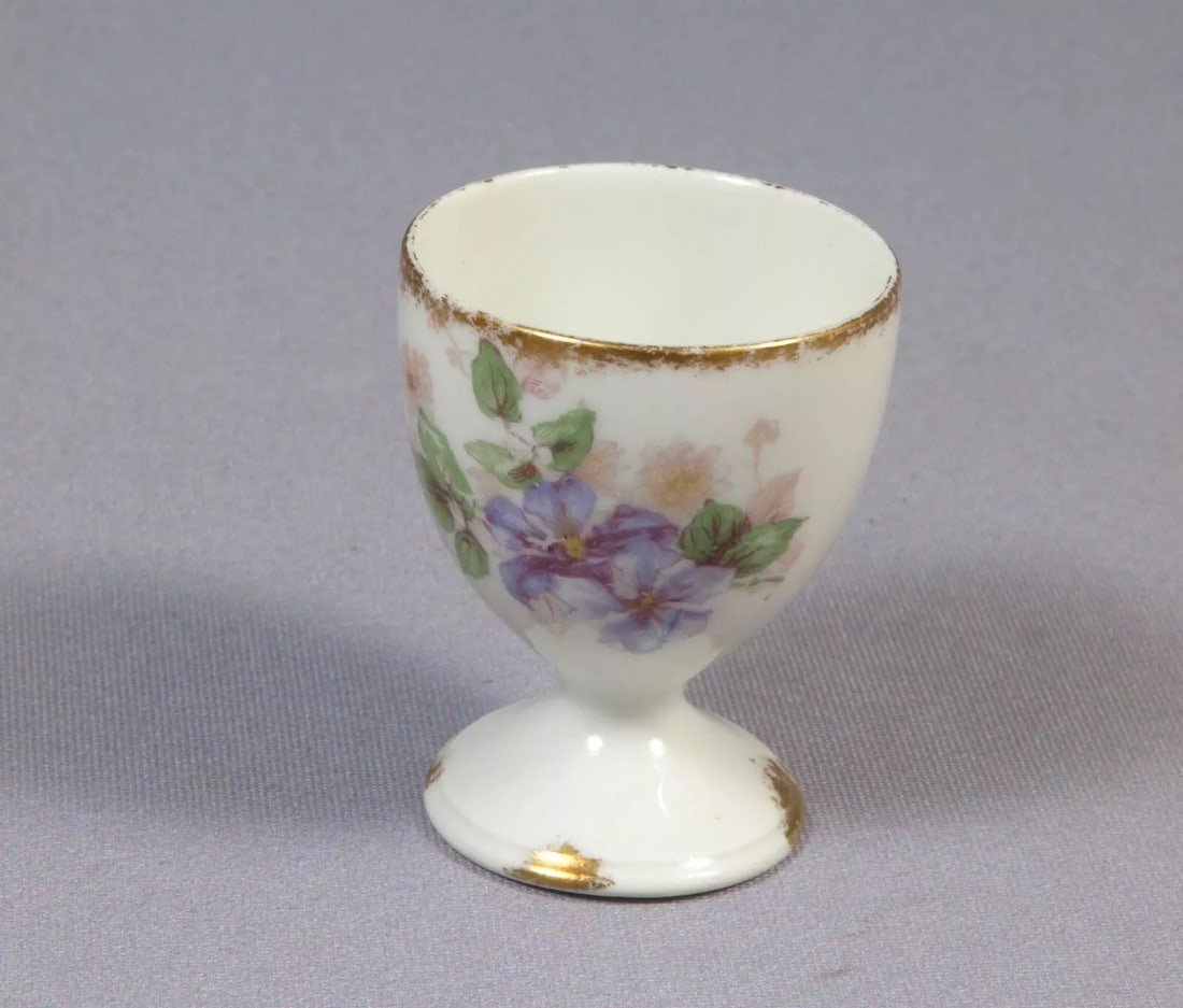 Limoges CH Field Haviland France EGG CUP Purple Flowers Clematis Vines: This is rare and hard to find Egg cup. The cup was made in CHField Haviland in Limoges, France. The cup is 1 7/8" in diameter and 2 3/8" deep It will make a wonderful gift or will be a great addition