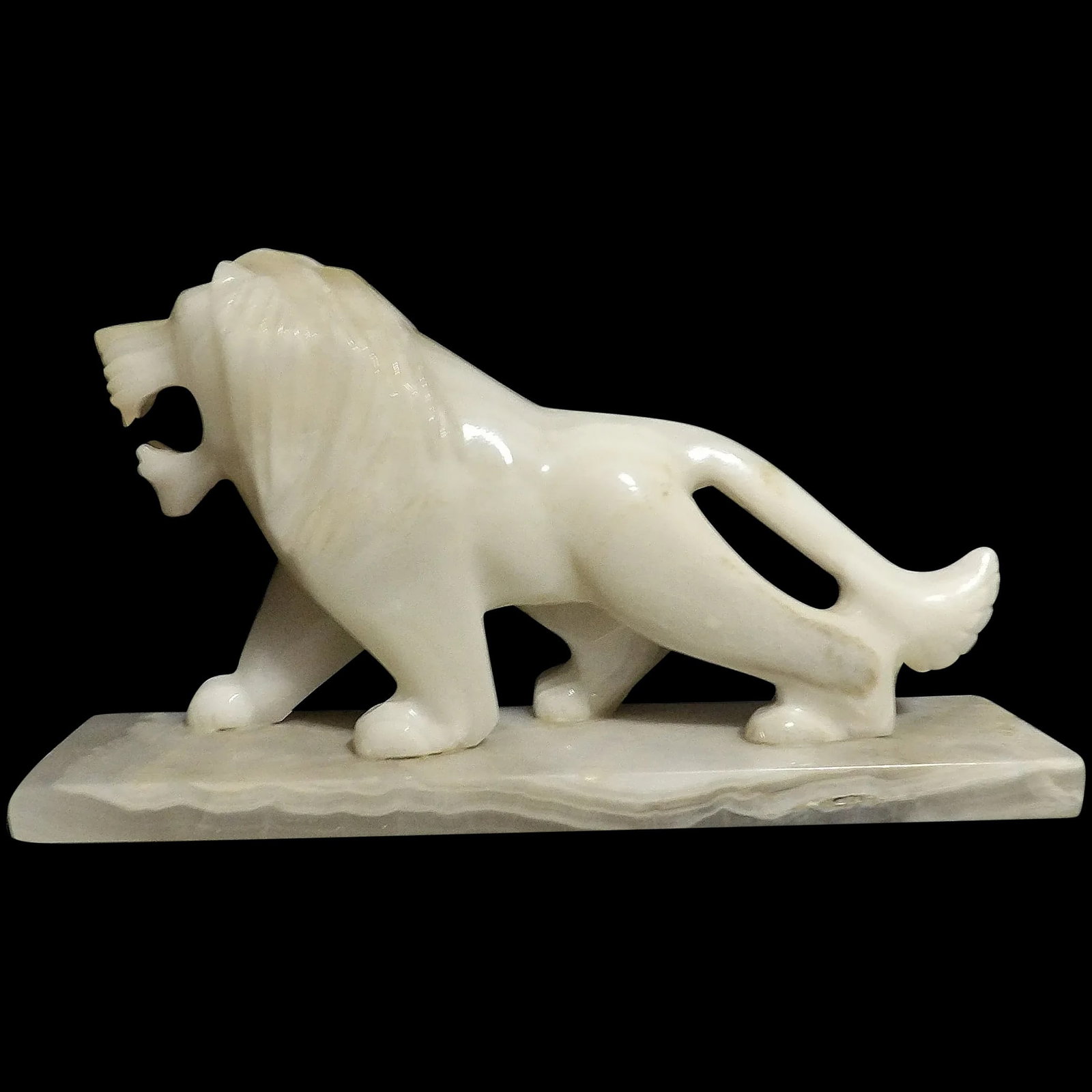 Vintage Hand Carved Roaring Onyx Lion: This Vintage Hand Carved Roaring Onyx Lion is in excellent condition. It measures 8 ½” x 4 ¾” x 2 ¼”. No chips or problems. Makes a great paperweight as well as a deco