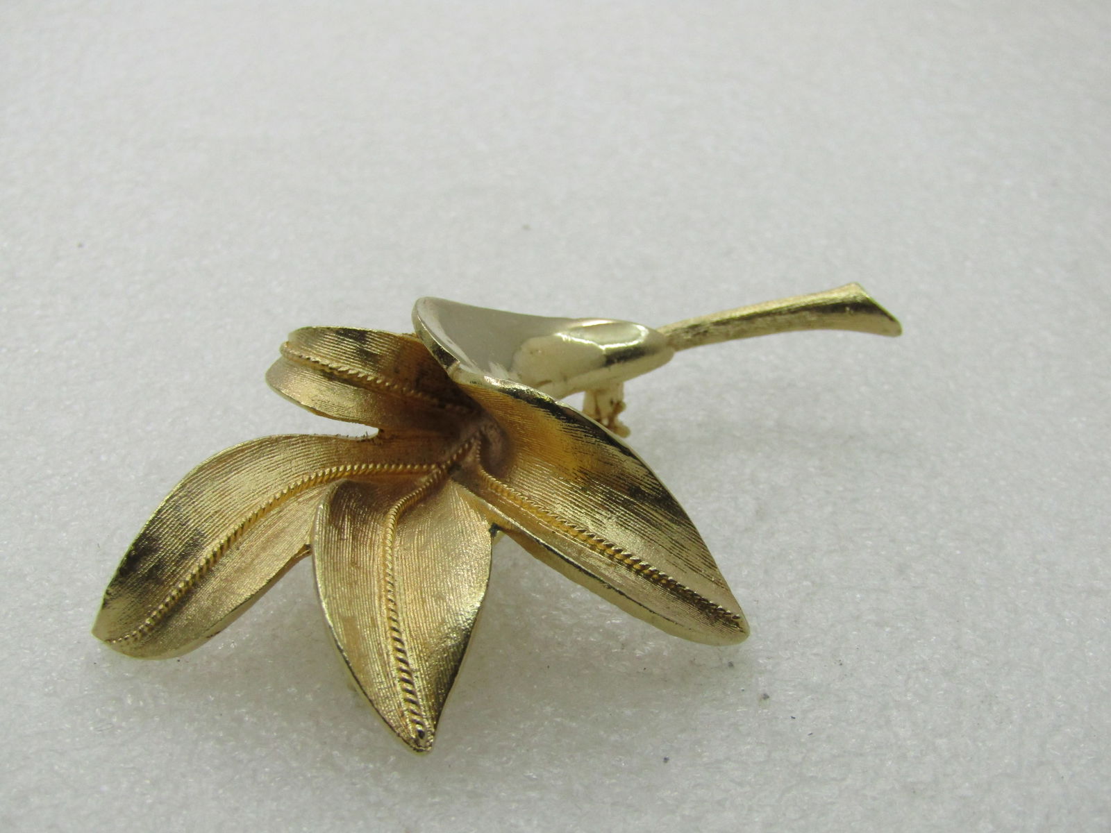 Vintage Coro Pegasus Lily Blossom Brooch, 1960's, 3": Vintage Coro Pegasus Lily Blossom Brooch, 1960's, 3" by 2". Textured and smooth finish. 1960's. Very good condition. Signed on back with the Pegasus image and Coro maker's mark. (INV. W?.1X1 SS3691 J