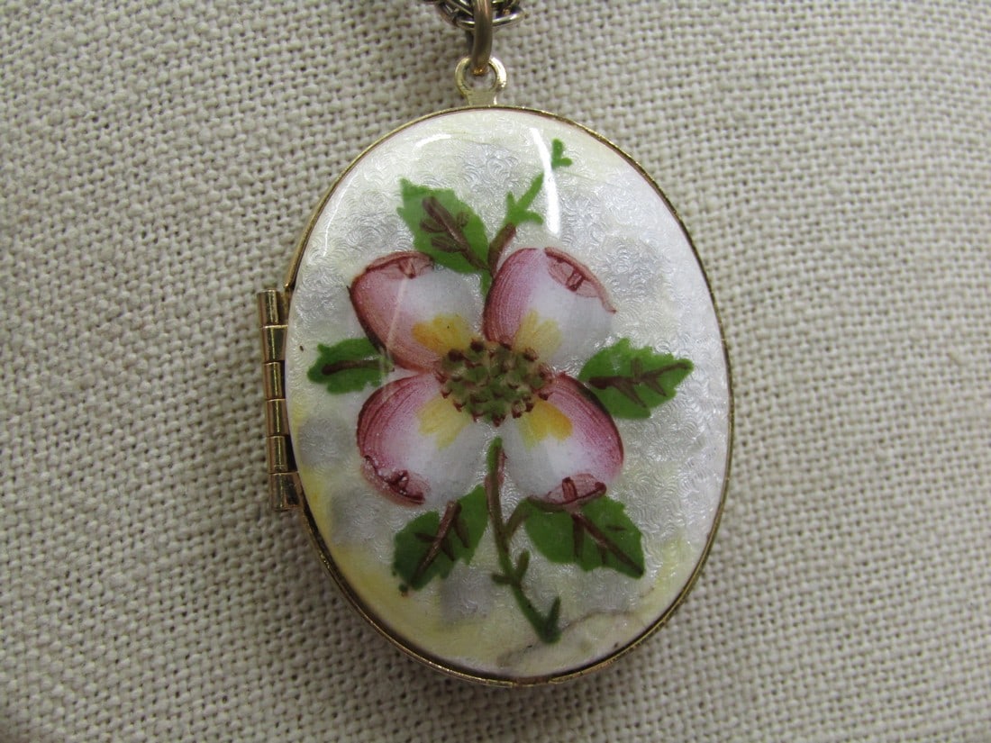 Vintage Guilloche Dogwood Blossom Locket Necklace, 24" Gold Tone, 1960's: Vintage Guilloche Dogwood Locket Necklace, 24" Gold Tone, 1960's. The locket is 2" tall with bail and 1.5" wide. The chain is a multi-link 3.5mm wide chain with sring clasp. It has a plcae for two pho