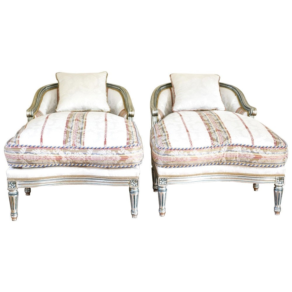 Hollywood Regency Louis XVI Chaise Lounges French Painted and Parcel Gilt Silver: Hollywood Regency Louis XVI style chaise lounges or extended marquees. The pair in a fine French painted and parcel gilt silver decorated frame with an exquisite matching fabric. Having hand silver le