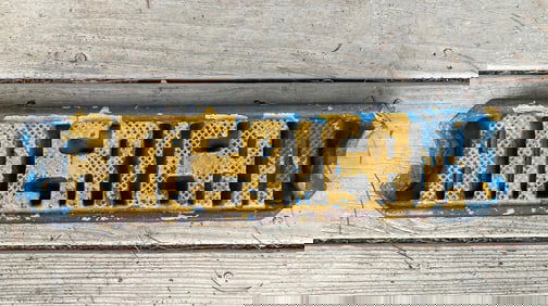 Mid 20thc AMERICAN cast iron ladder step with old blue and yellow paint