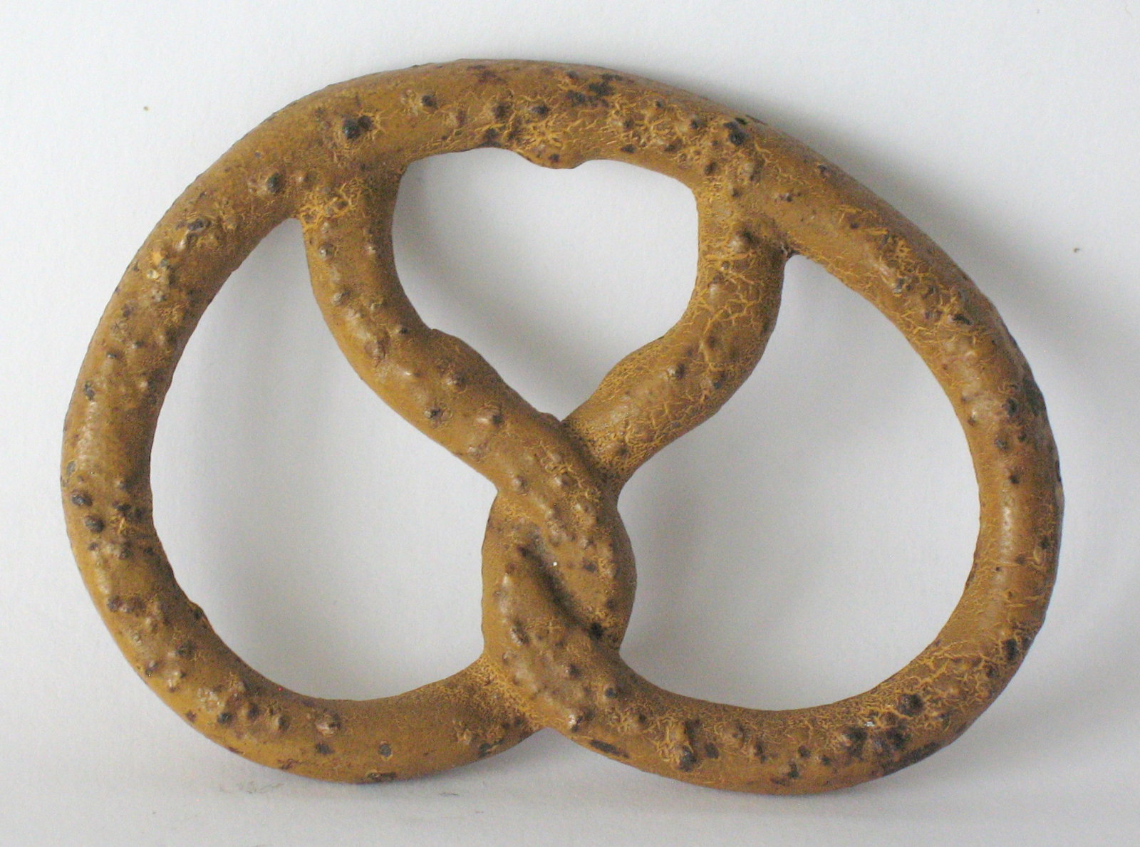 Vintage cast iron pretzel shaped bottle opener.: Title: Vintage cast iron pretzel shaped bottle opener. Date/Period: 1950's Dimension: 3 1/2” Additional Information: Nice vintage cast iron pretzel shaped bottle opener in great all original pai